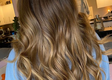 Golden brown wavy hairstyle at Hair Crown, London, England, GB, showcasing luxurious salon results.