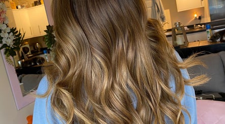 Golden brown wavy hairstyle at Hair Crown, London, England, GB, showcasing luxurious salon results.
