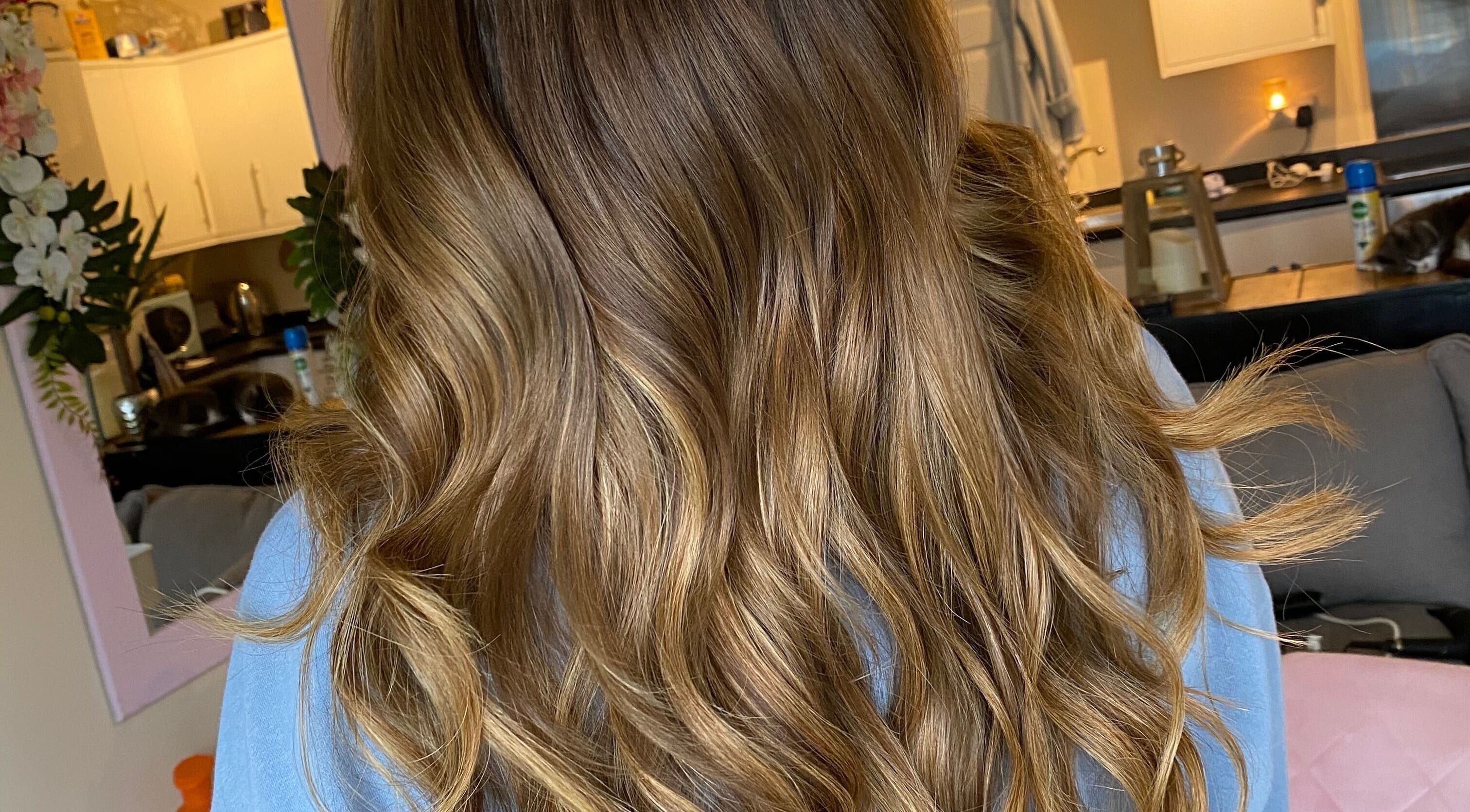 Golden brown wavy hairstyle at Hair Crown, London, England, GB, showcasing luxurious salon results.