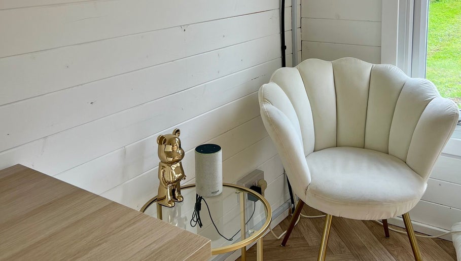 Elegant white chair and gold decor in The Beauty Forest, Middleton, England, GB. Modern and serene setting.