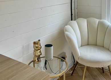Elegant white chair and gold decor in The Beauty Forest, Middleton, England, GB. Modern and serene setting.