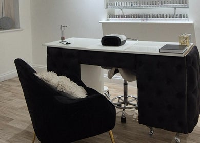 Chic nail studio at Meraki in Shaw, England, GB featuring a modern manicure setup and shelves of nail polish.