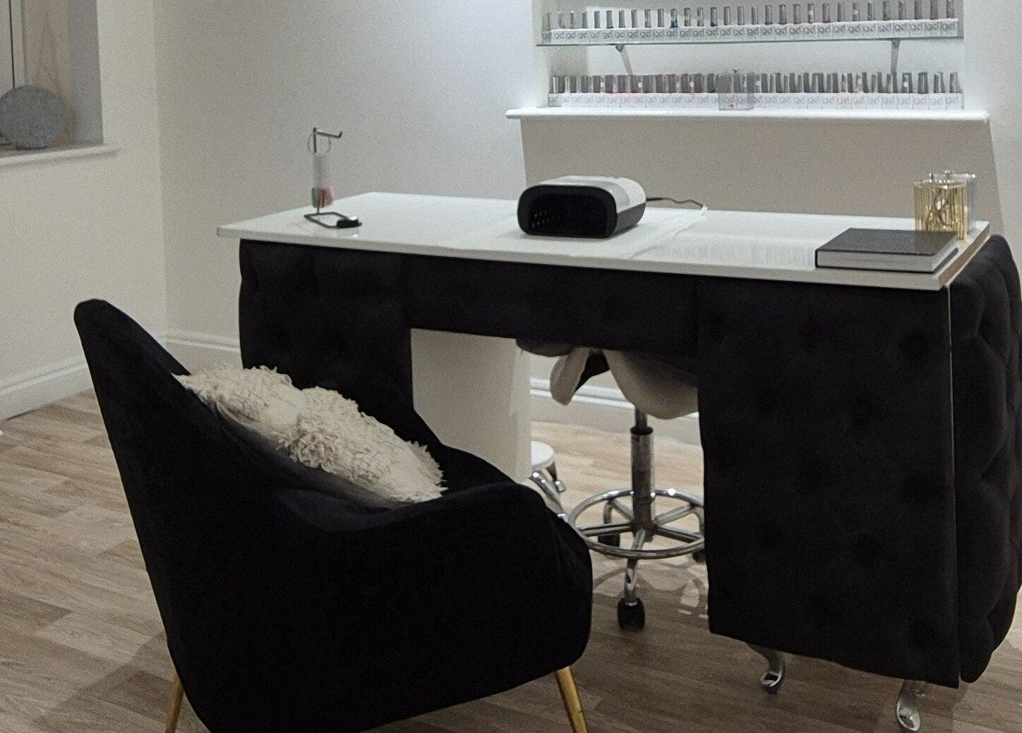 Chic nail studio at Meraki in Shaw, England, GB featuring a modern manicure setup and shelves of nail polish.