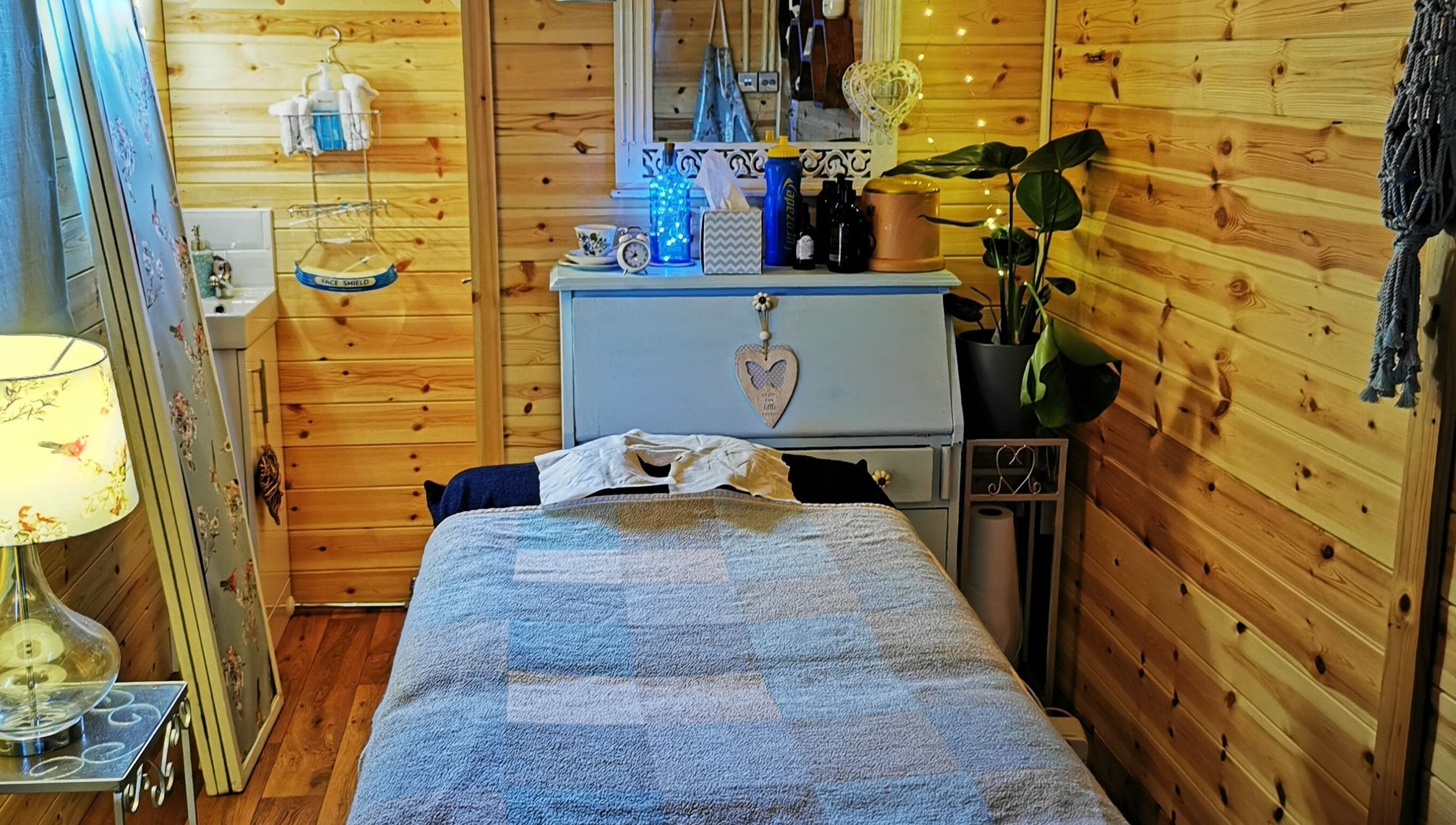 Tranquil massage room at Essence Mind and Body, Leeds, England, GB with wooden interiors and soft lighting.