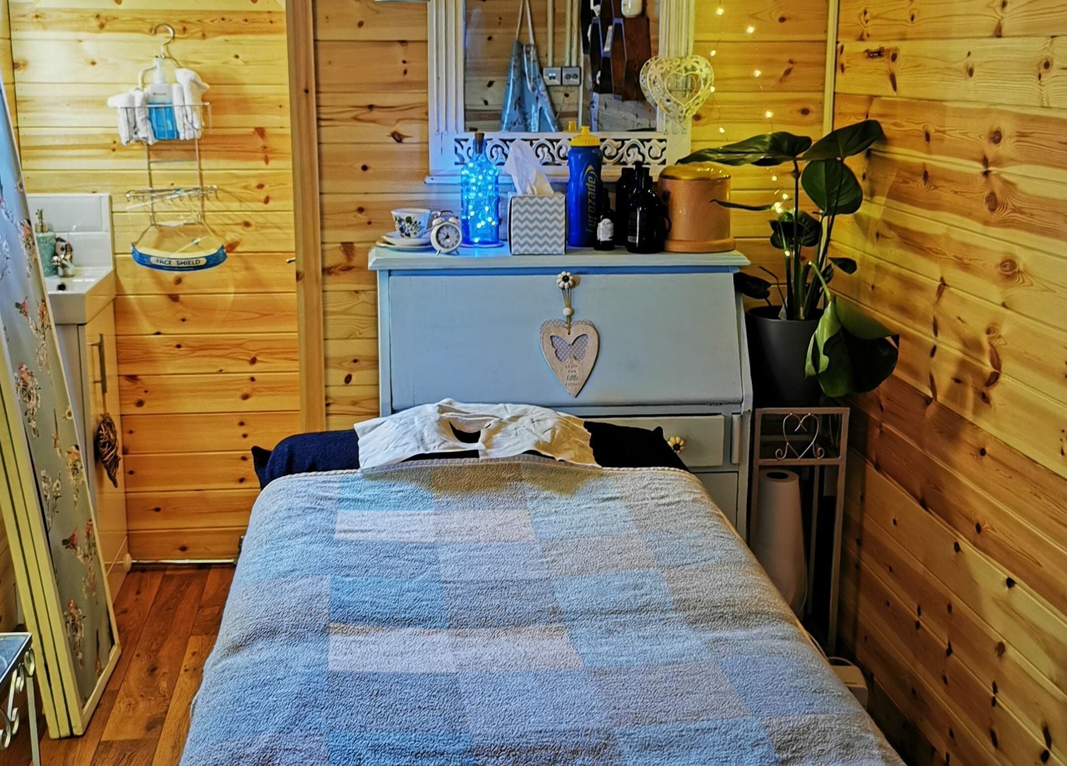Tranquil massage room at Essence Mind and Body, Leeds, England, GB with wooden interiors and soft lighting.