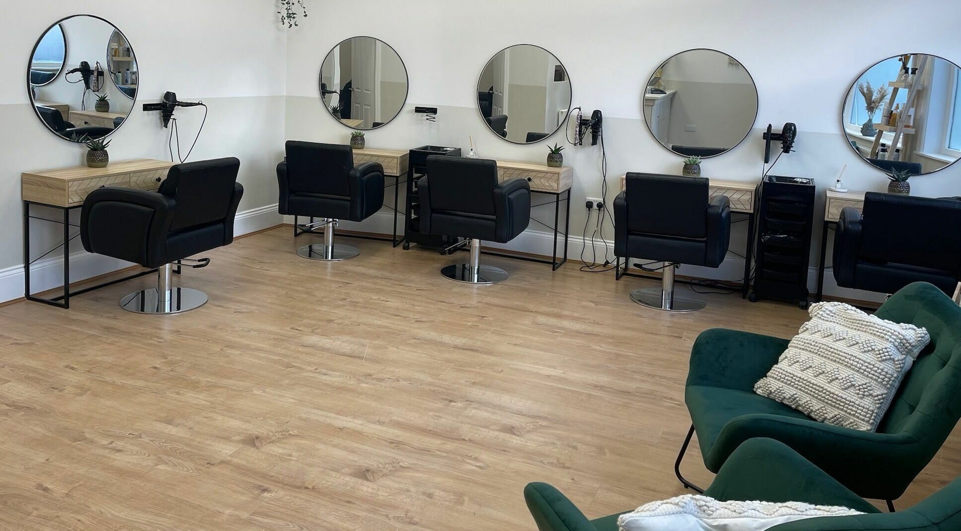 Modern styling area at ASC Hair & Beauty, Mansfield, England, GB, featuring elegant chairs and mirrors.