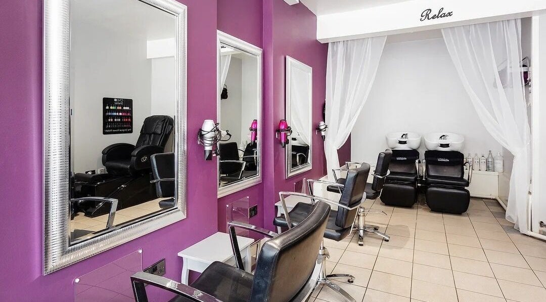 Taylor’d Hair and Beauty salon interior in London, England, GB with chic styling chairs and mirrors.