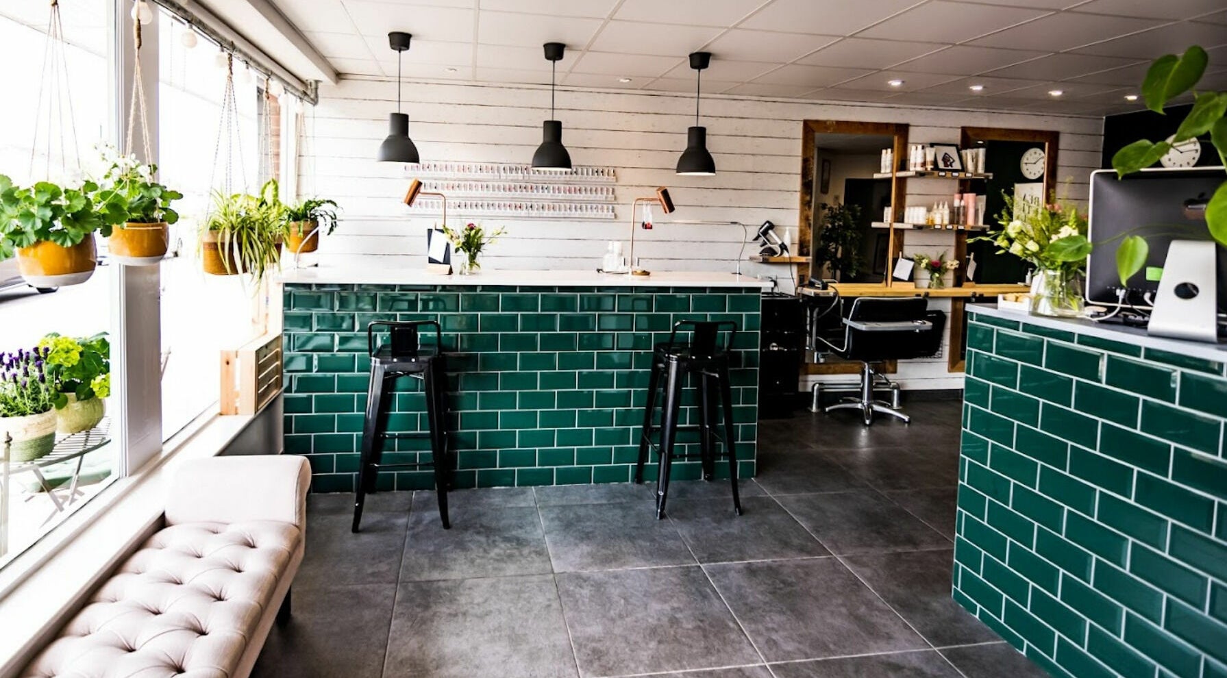 Chic interior of The Rooms in Stotfold, England, GB featuring modern decor and lush green plants.