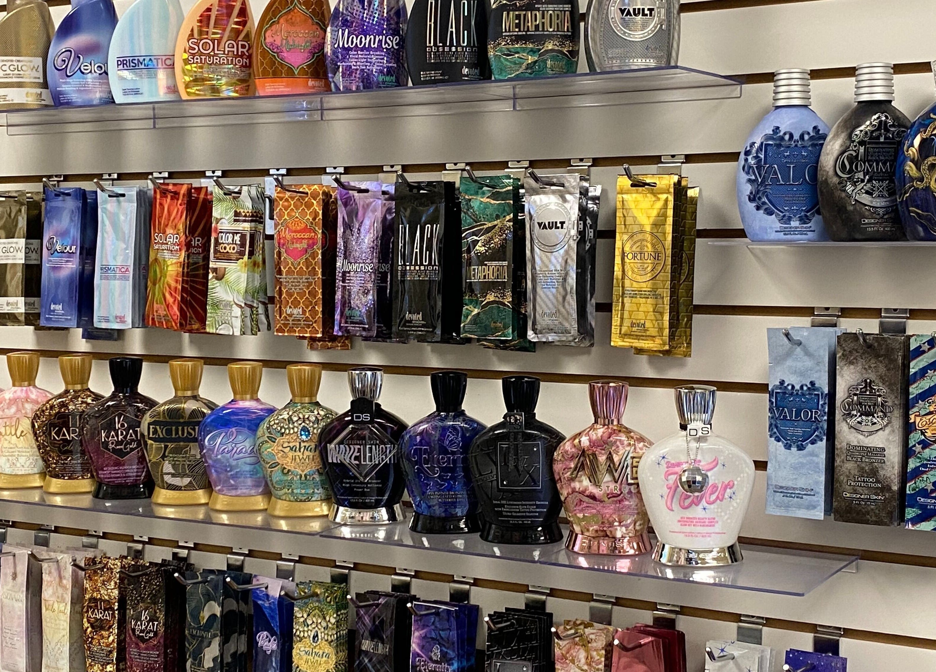 Assorted luxury tanning lotions on display at Solar Image, Lufkin, Texas, US, showcasing various packaging designs.