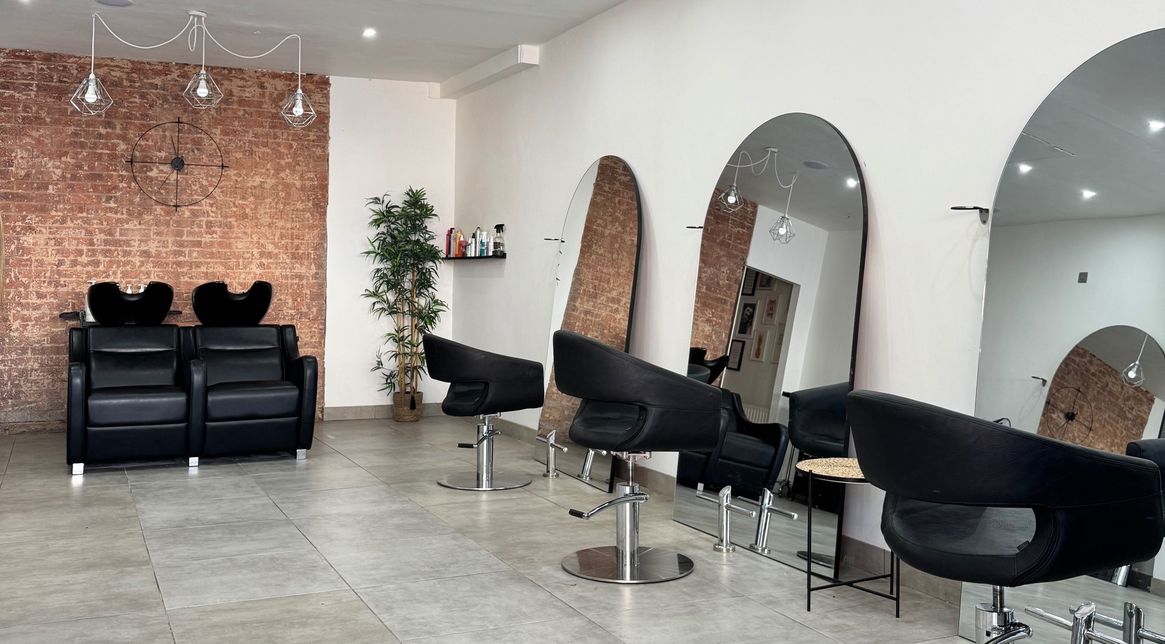 Modern salon interior at Image London - Bermondsey, featuring sleek chairs and mirrors in London, England, GB.