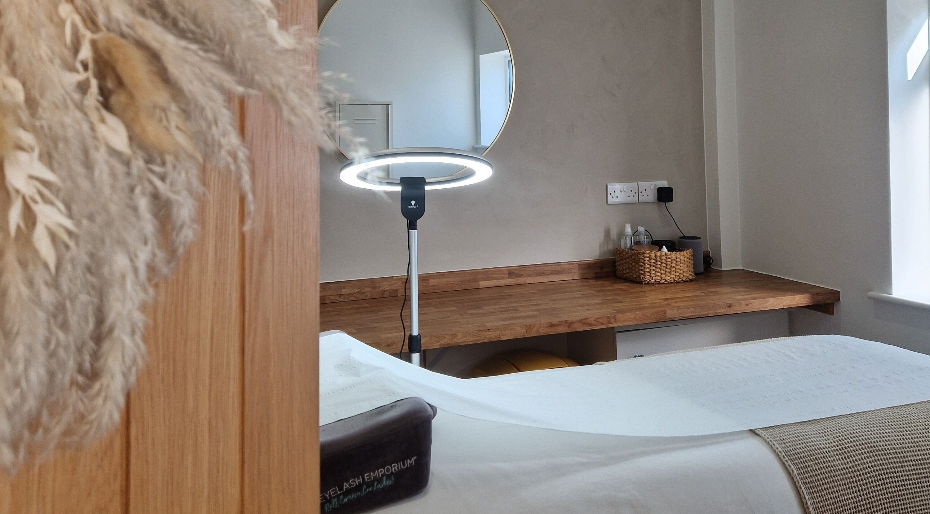 Relaxing spa set up at Beccaelizabethcosmetics, Stamford, England, with a beauty bed and mirror.