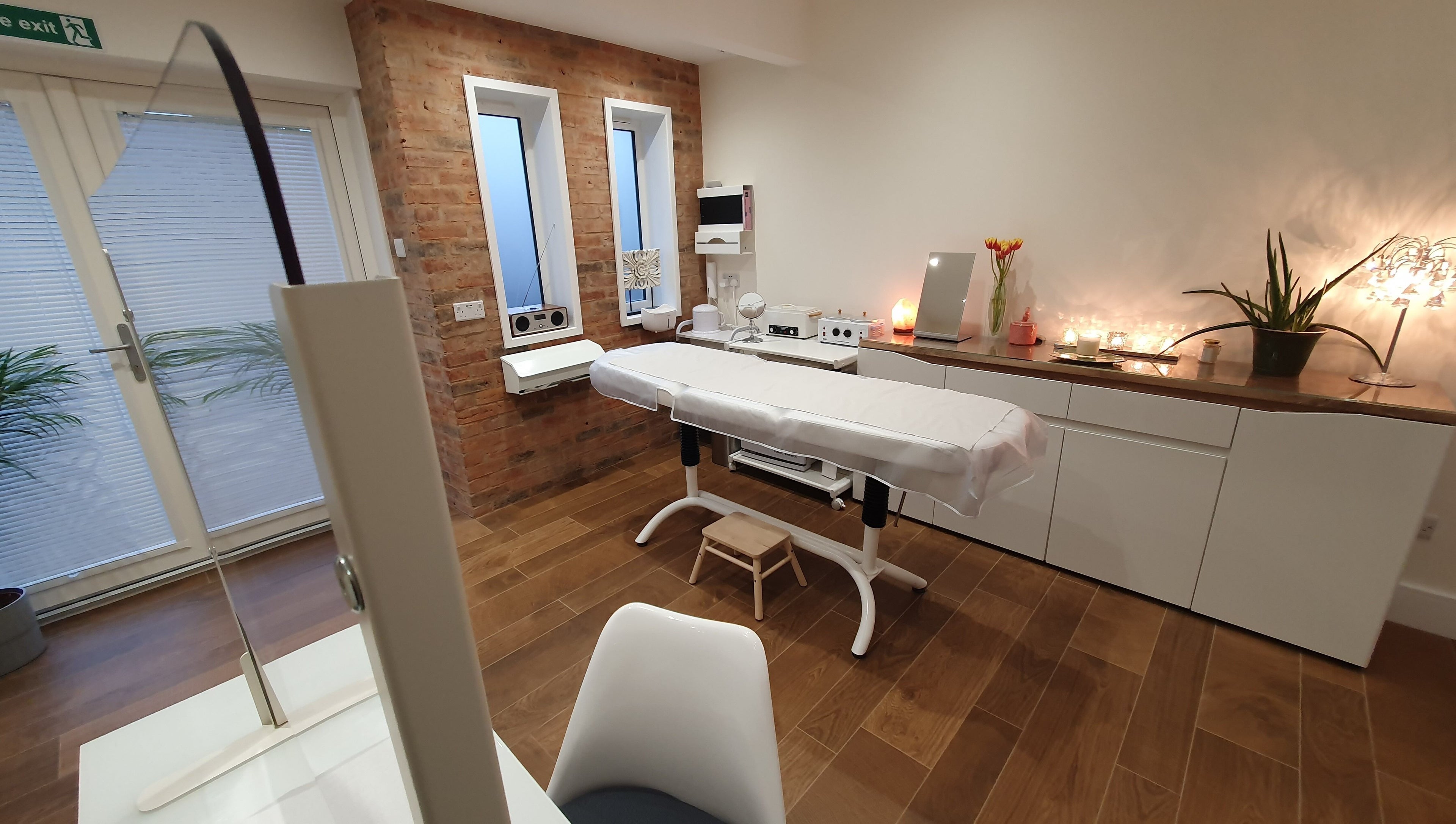 Relaxing treatment room at Anstey Beauty in Leicester, England, GB, featuring a comfortable massage table.