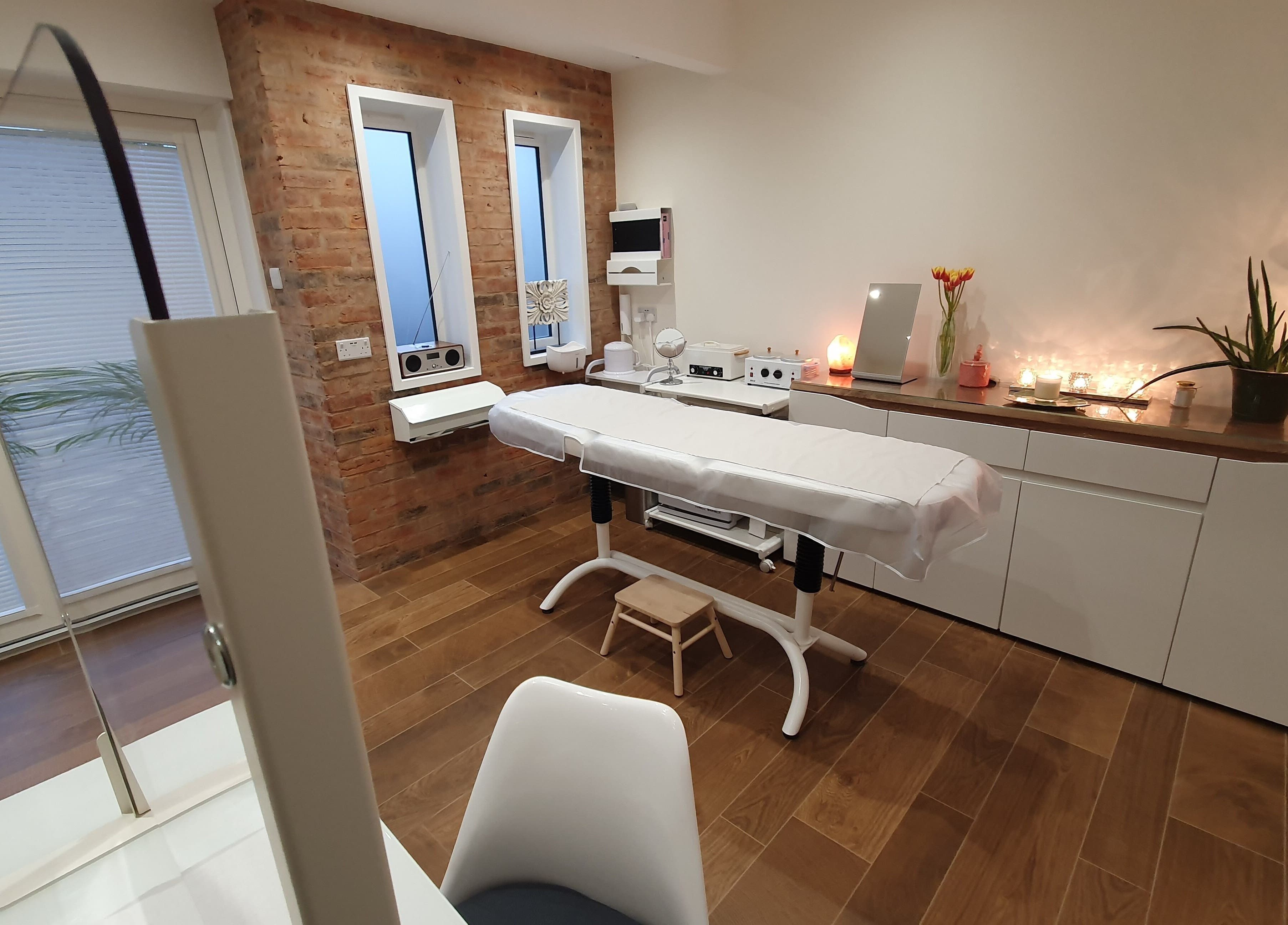 Relaxing treatment room at Anstey Beauty in Leicester, England, GB, featuring a comfortable massage table.