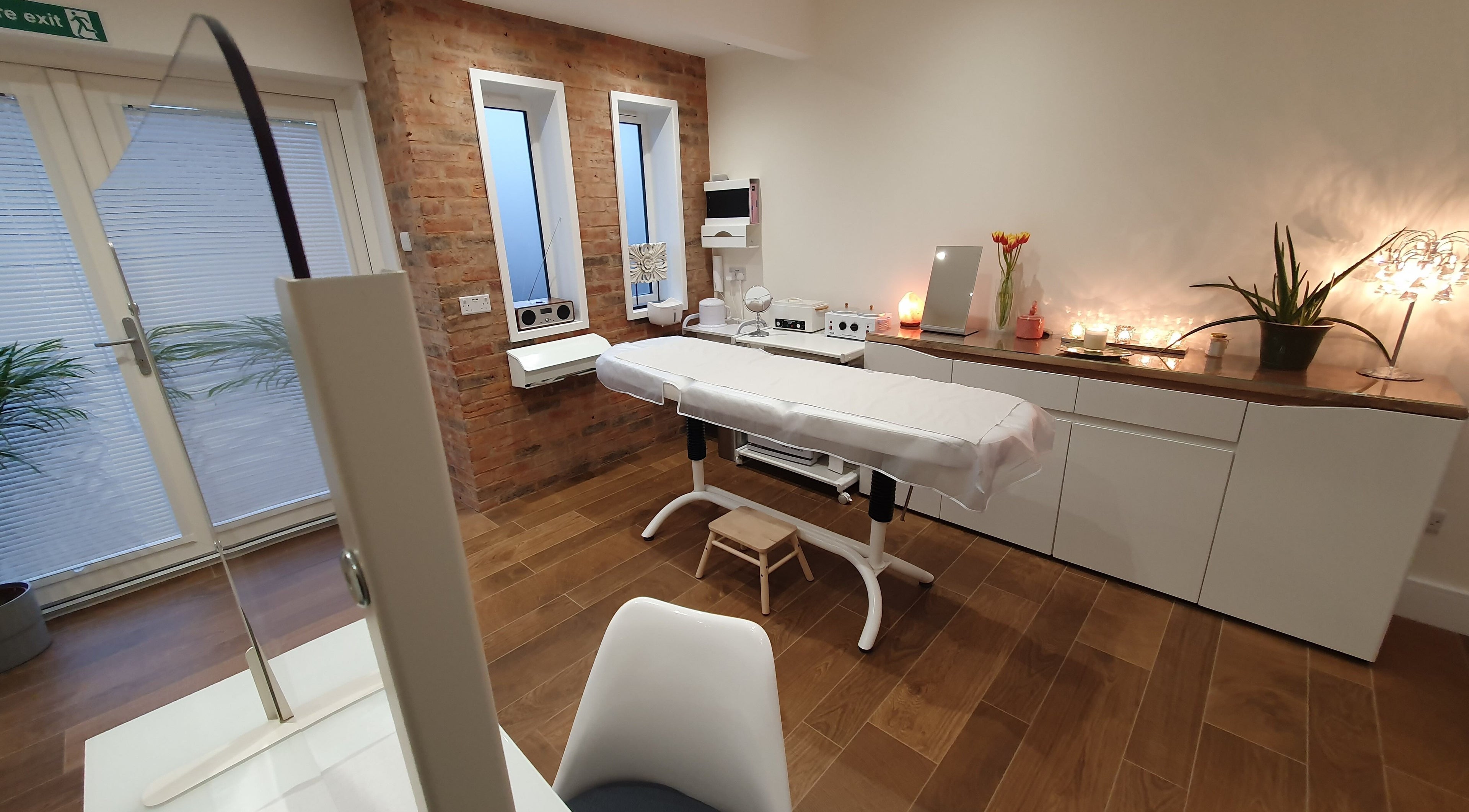 Relaxing treatment room at Anstey Beauty in Leicester, England, GB, featuring a comfortable massage table.
