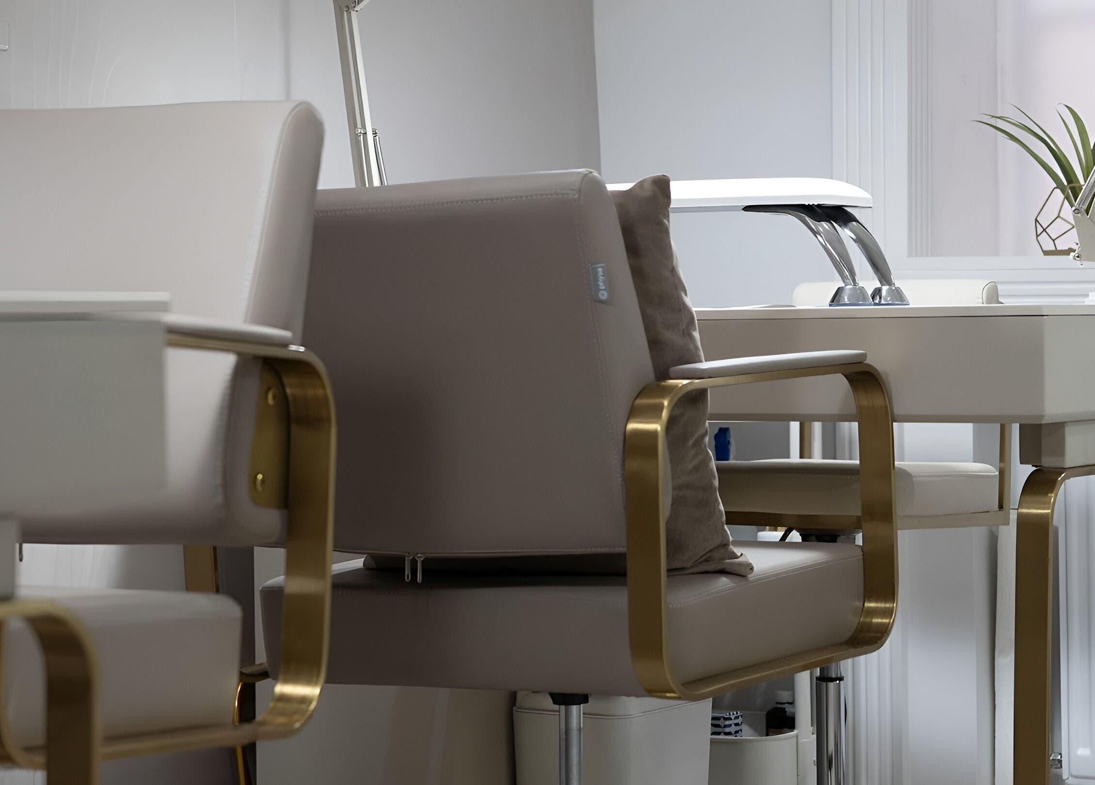 Elegant manicure station at Oxygen Beauty London, featuring plush chairs and decor in London, England, GB.