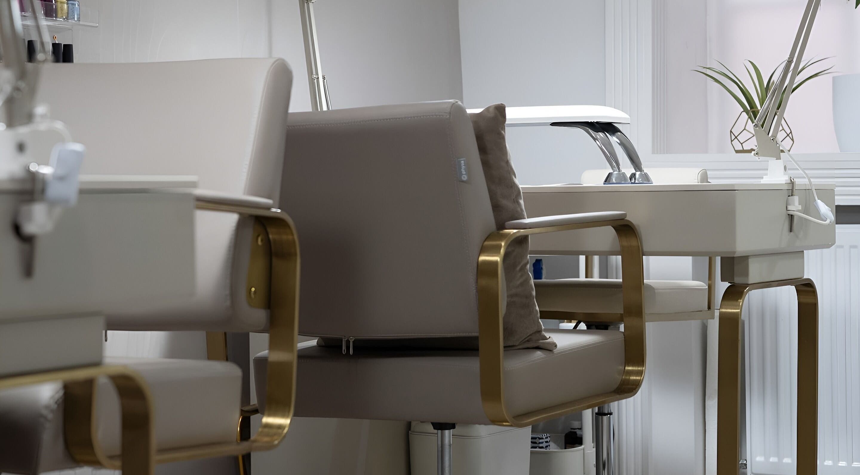 Elegant manicure station at Oxygen Beauty London, featuring plush chairs and decor in London, England, GB.
