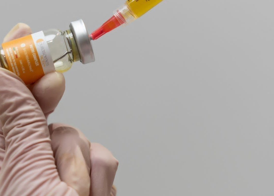 Syringe drawing liquid from vial at Oxygen Beauty London, London, England, GB, for cosmetic treatment.