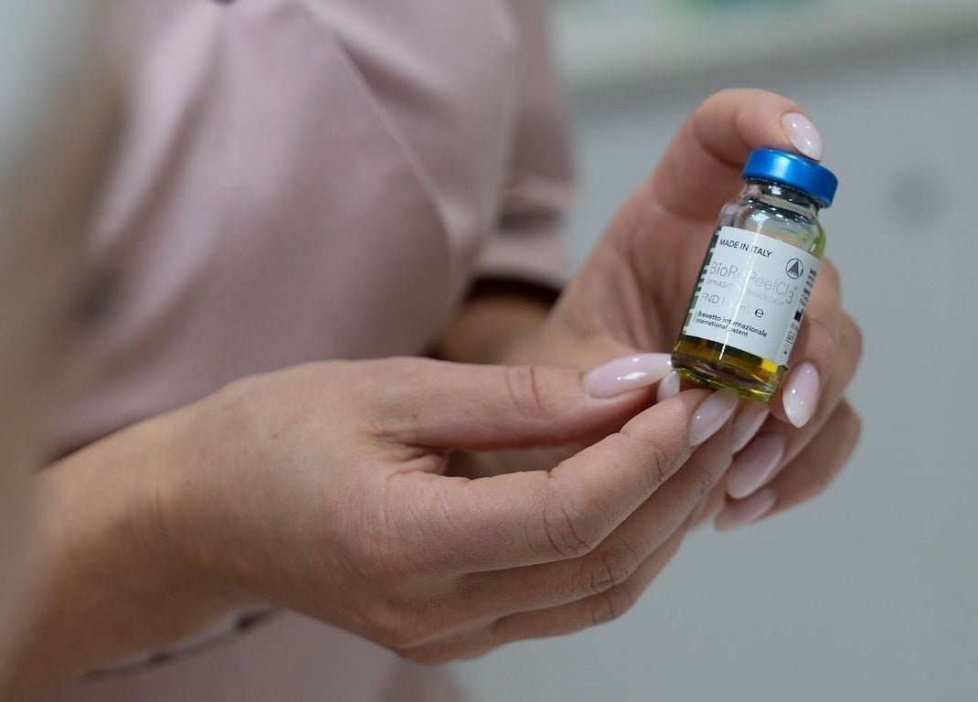 Close-up of hands holding serum at Oxygen Beauty London, London, England, GB emphasizing beauty care.