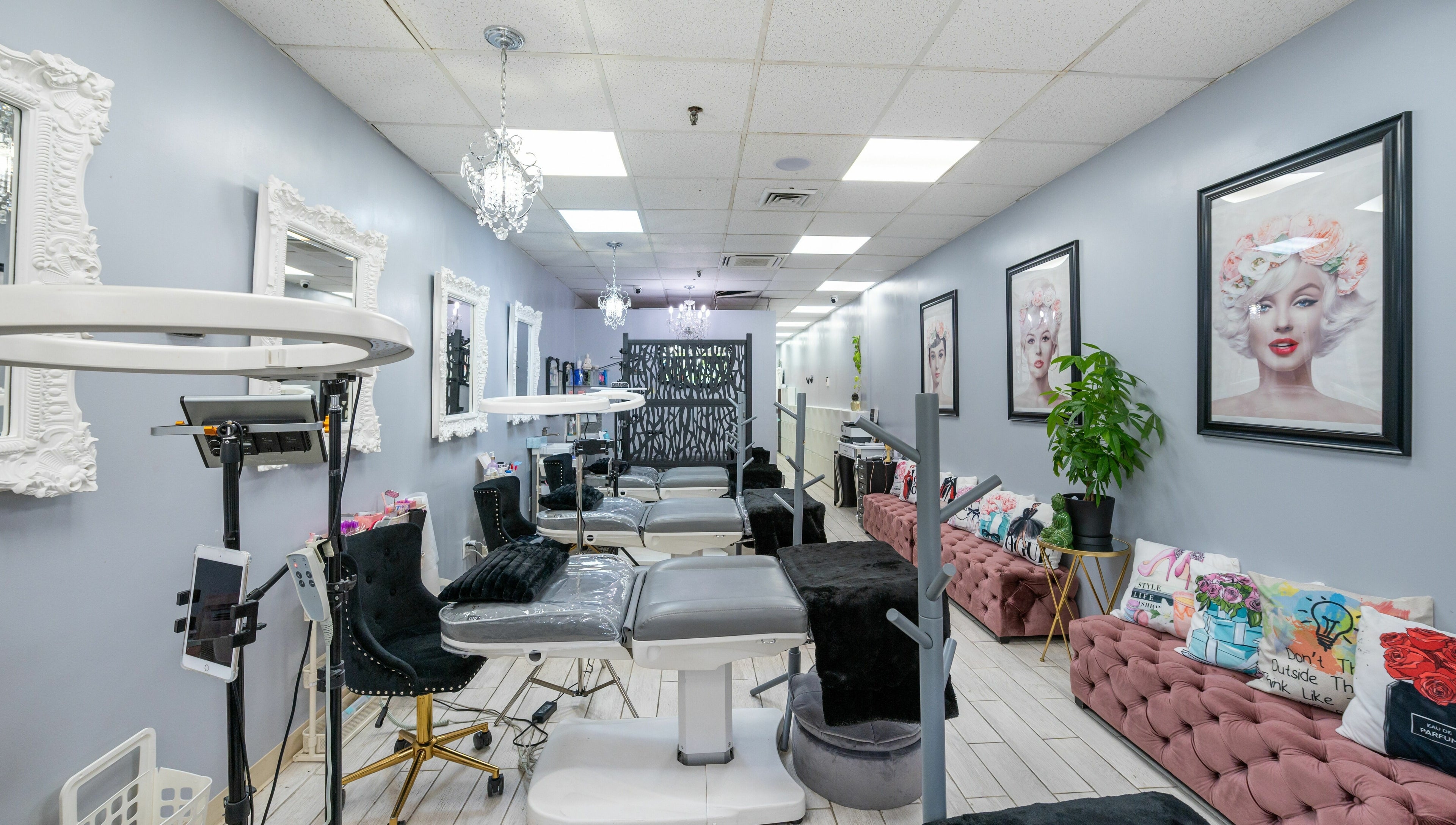 Interior of Boom Brows Lash Bar, a chic beauty salon in Bethpage, New York, US, featuring elegant decor and styling chairs.