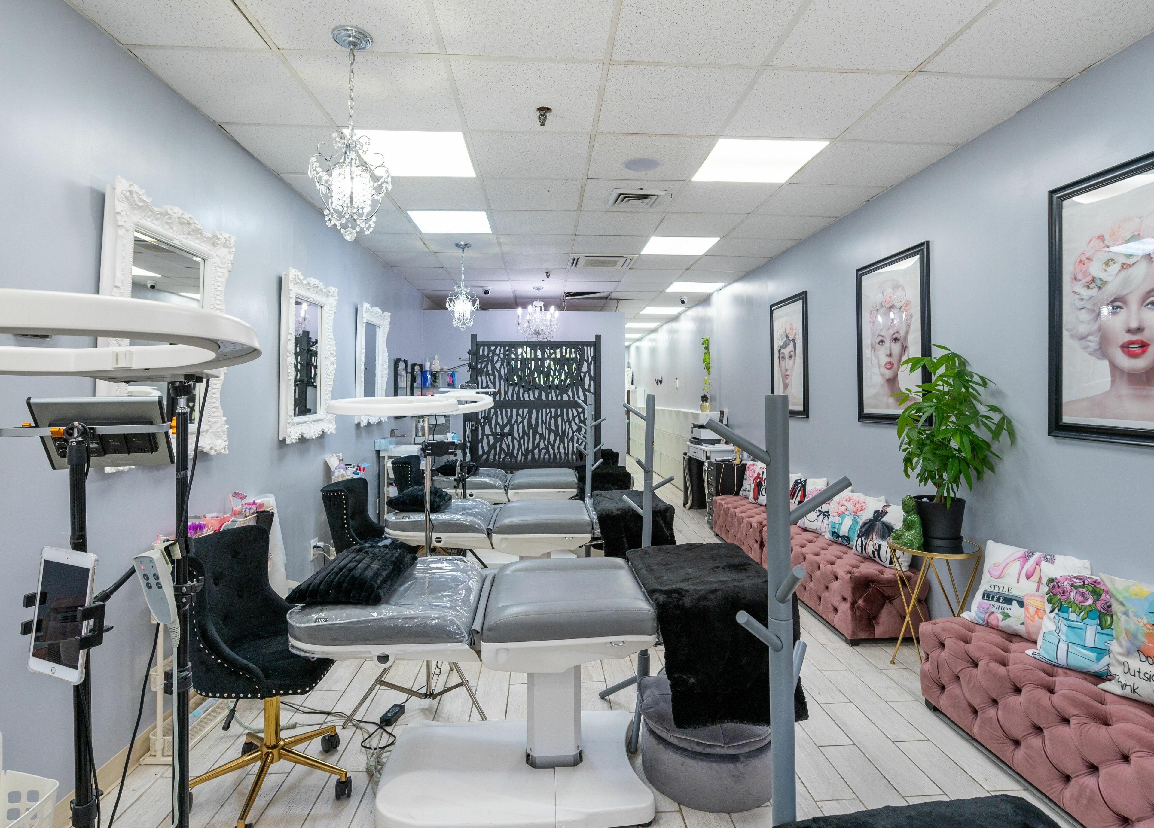 Interior of Boom Brows Lash Bar, a chic beauty salon in Bethpage, New York, US, featuring elegant decor and styling chairs.