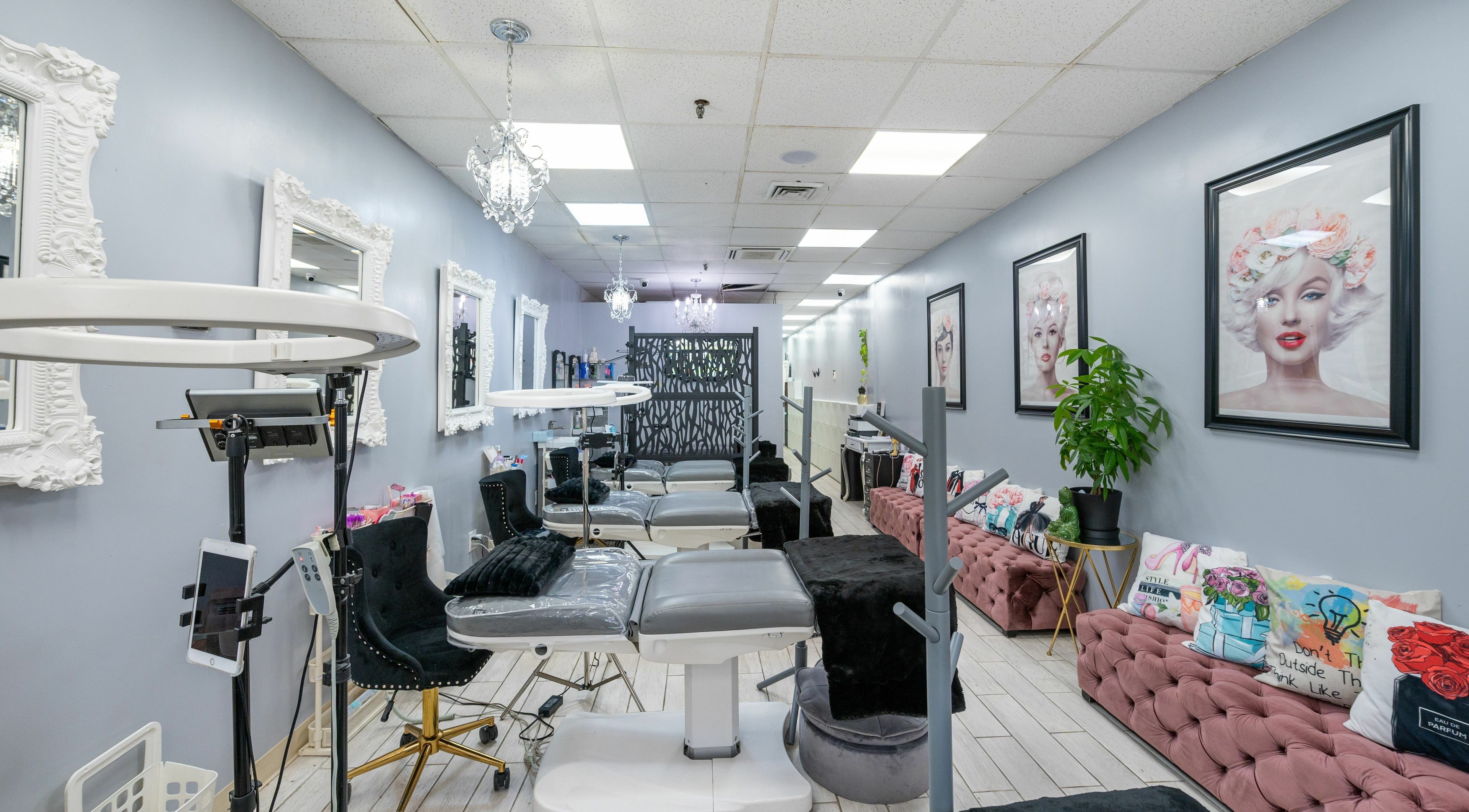 Interior of Boom Brows Lash Bar, a chic beauty salon in Bethpage, New York, US, featuring elegant decor and styling chairs.