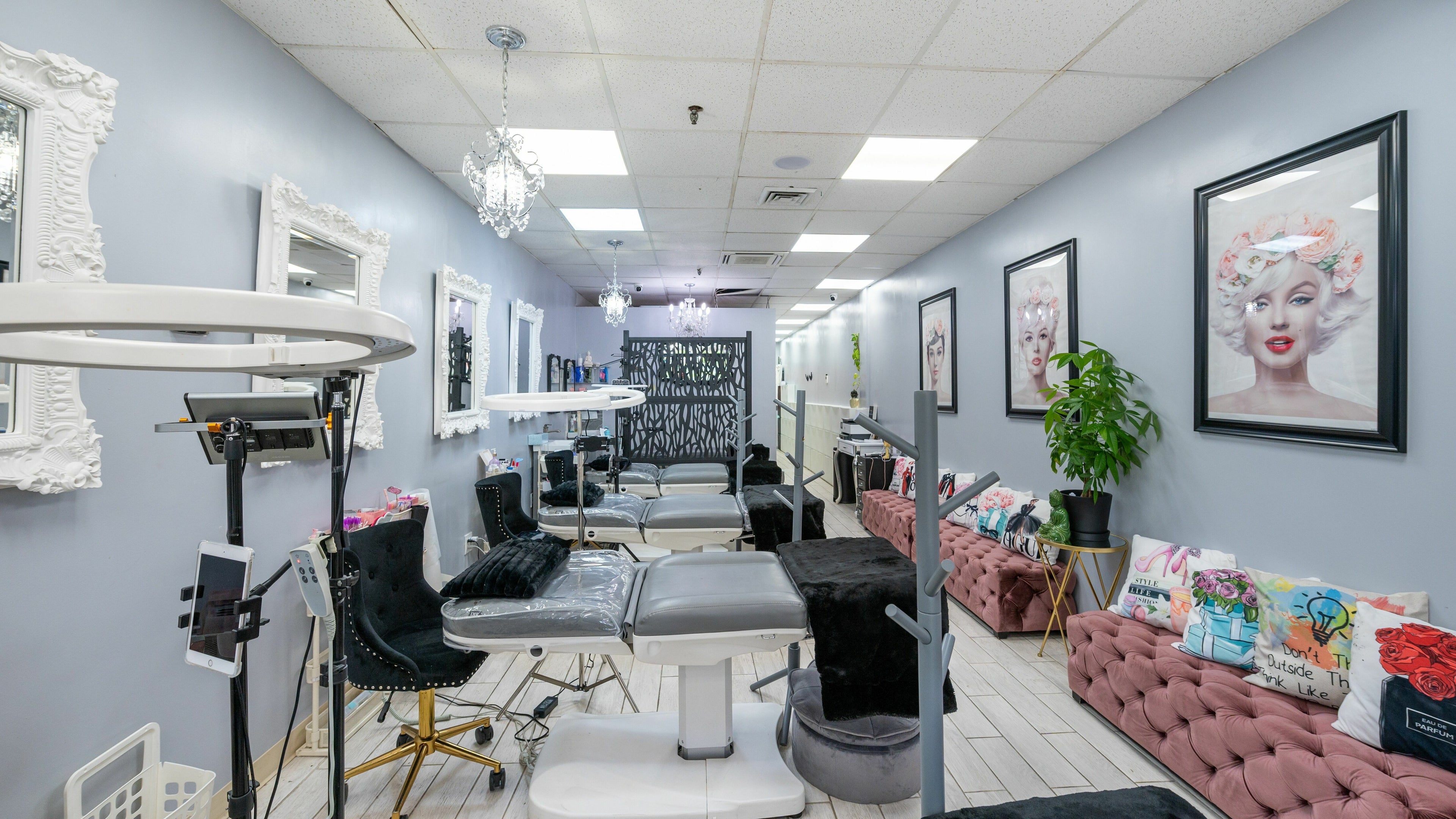 Interior of Boom Brows Lash Bar, a chic beauty salon in Bethpage, New York, US, featuring elegant decor and styling chairs.
