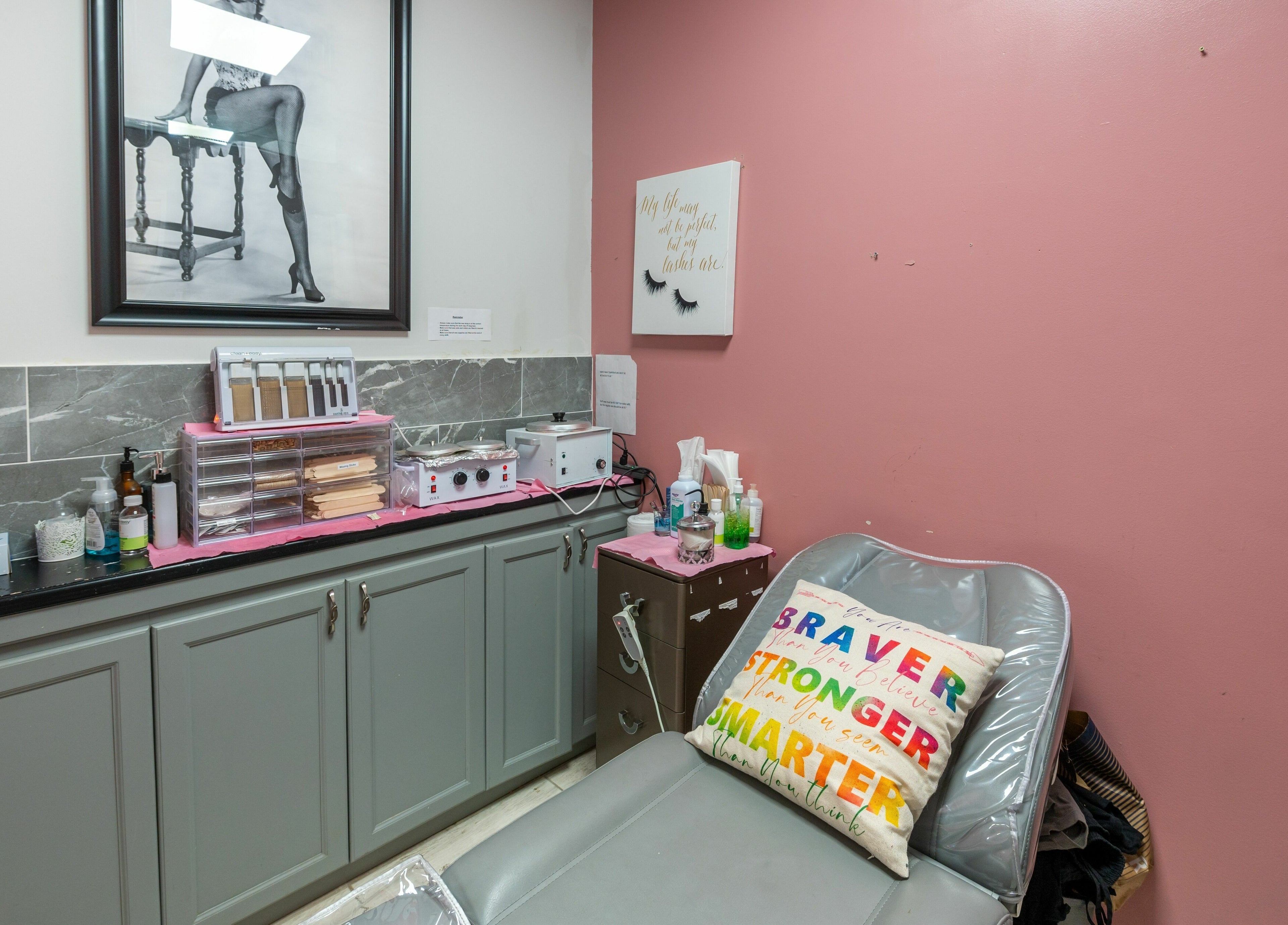 Cozy treatment room at Boom Brows Lash Bar, Bethpage, New York, US with a pink wall and stylish decor.