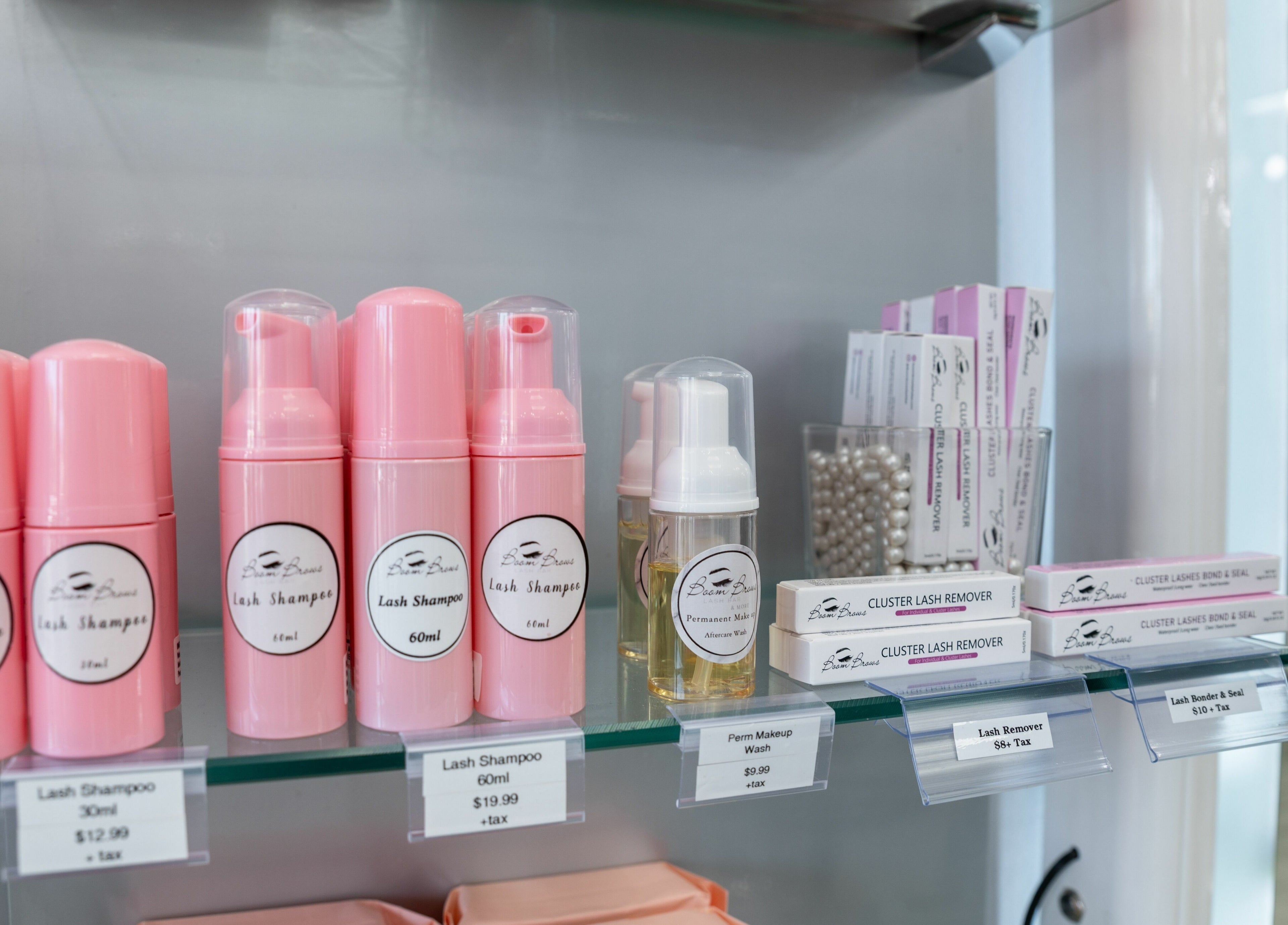 Lash care products at Boom Brows Lash Bar, Bethpage, New York, US. Range includes shampoos and lash remover.
