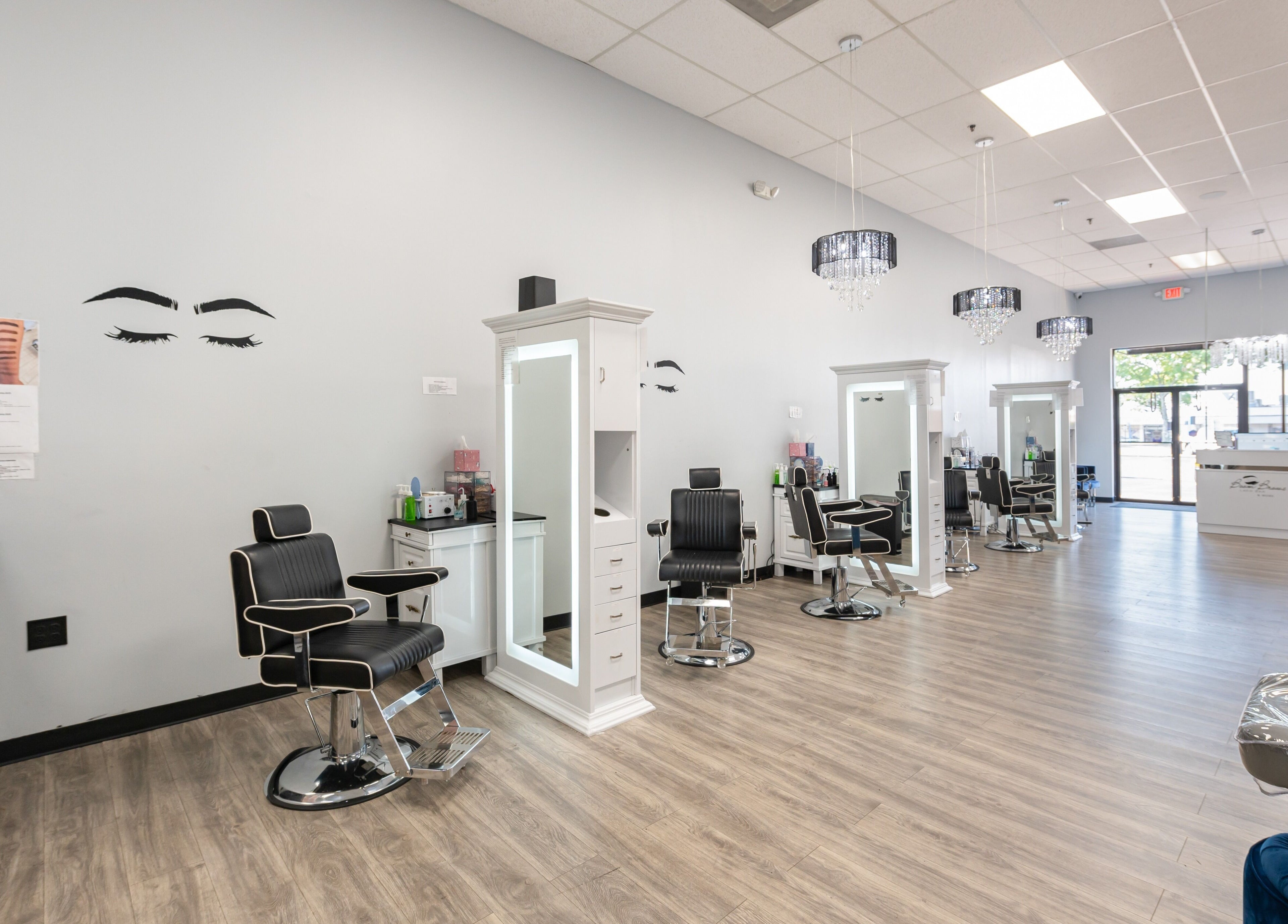Chic interior of Boom Brows Lash Bar and More, Farmingdale, New York, US with stylish seating and mirrors.
