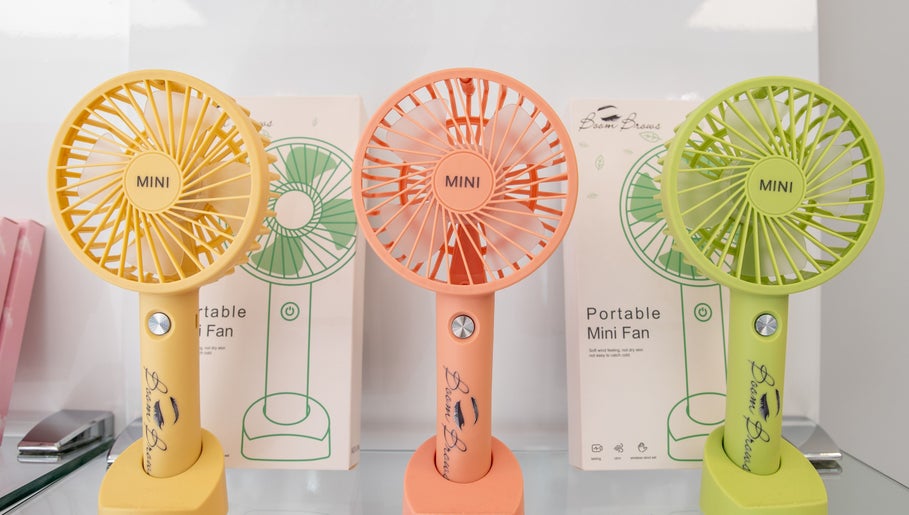 Colorful mini fans at Boom Brows Lash Bar By Liz, Massapequa Park, New York, US, stylish decor detail.
