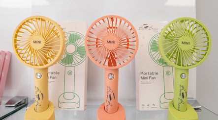 Colorful mini fans at Boom Brows Lash Bar By Liz, Massapequa Park, New York, US, stylish decor detail.