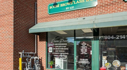Front view of Boom Brows Lash Bar By Liz in Massapequa Park, New York, US. Brick exterior and glass doors.