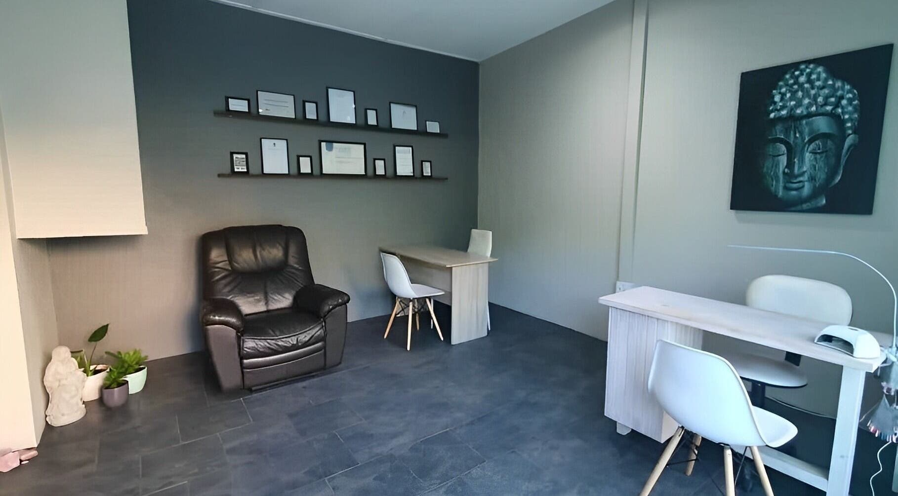 Cozy ALS Beauty lounge in Cape Town, Western Cape, ZA with Buddha art and seating area.