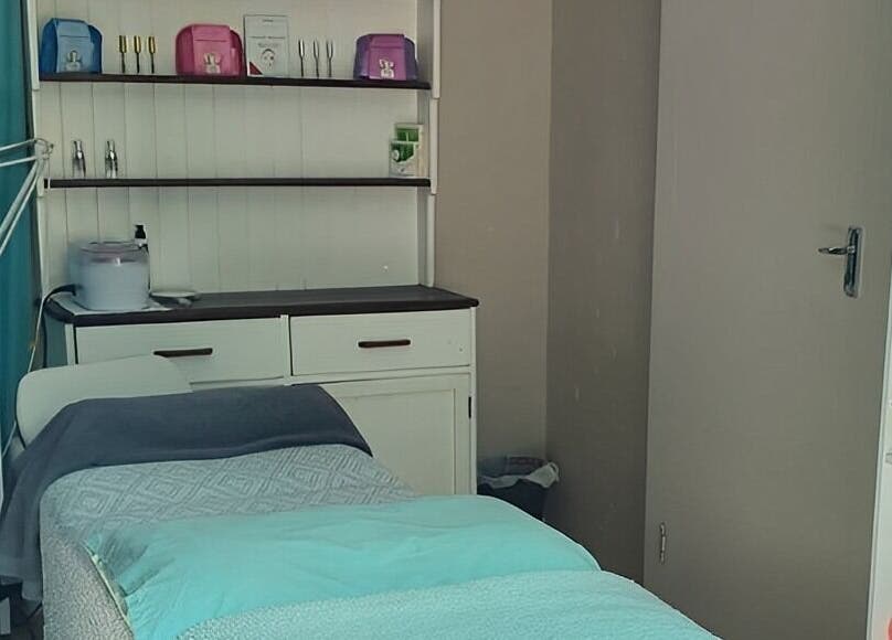 Tranquil treatment room at ALS Beauty in Cape Town, Western Cape, ZA featuring a cozy massage bed.