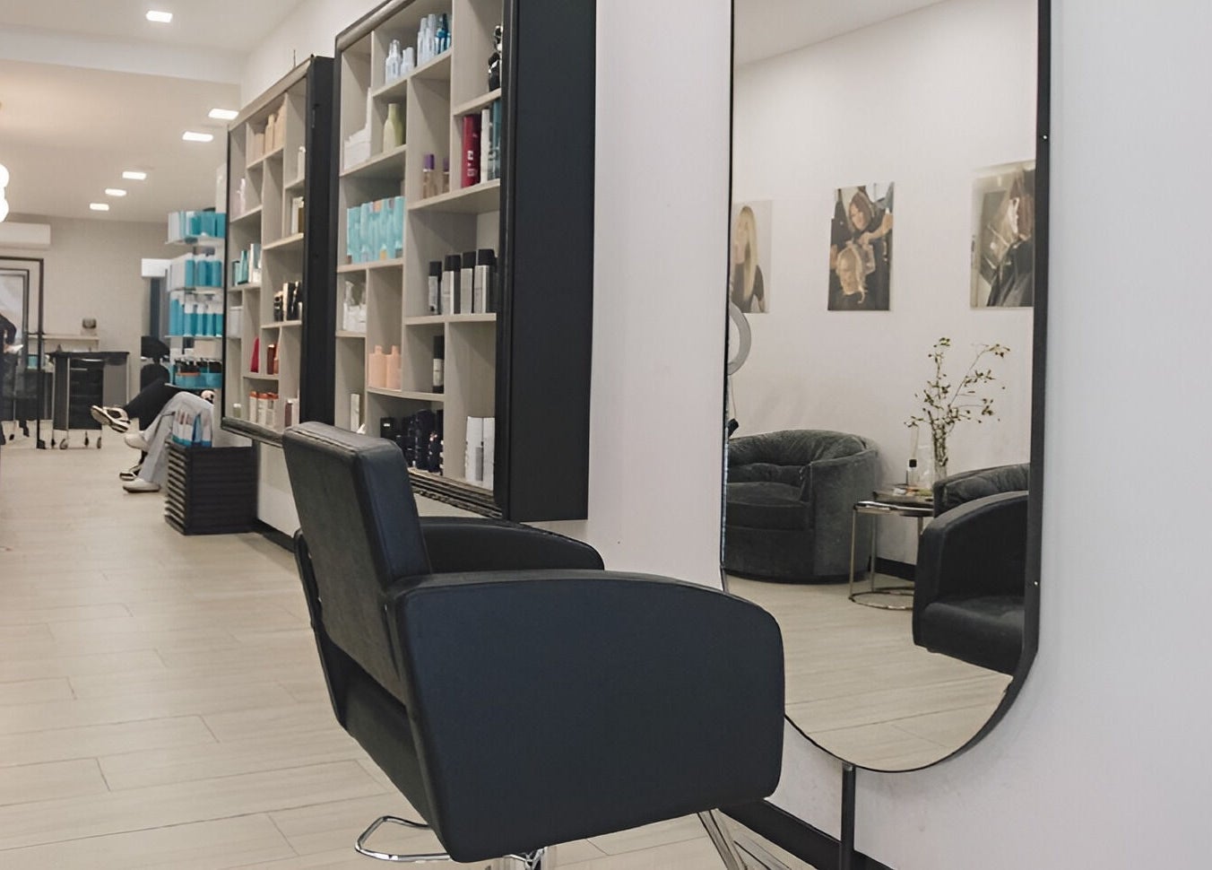 Elena Salon Sliema's elegant interior in Sliema, MT showcasing modern chairs, mirrors, and product shelves.