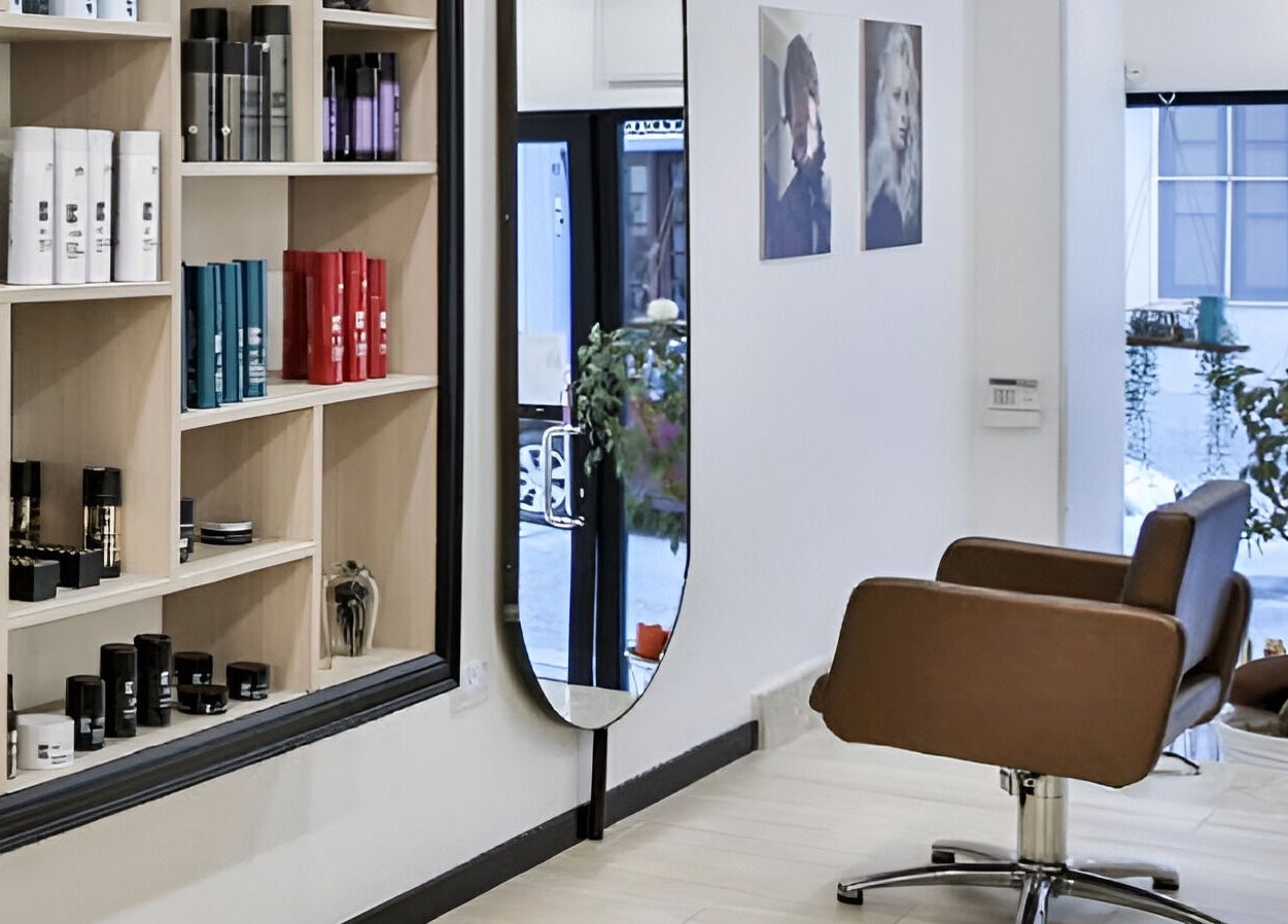 Stylish salon interior at Elena Salon Sliema in Sliema, MT, featuring hair products and sleek styling chair.