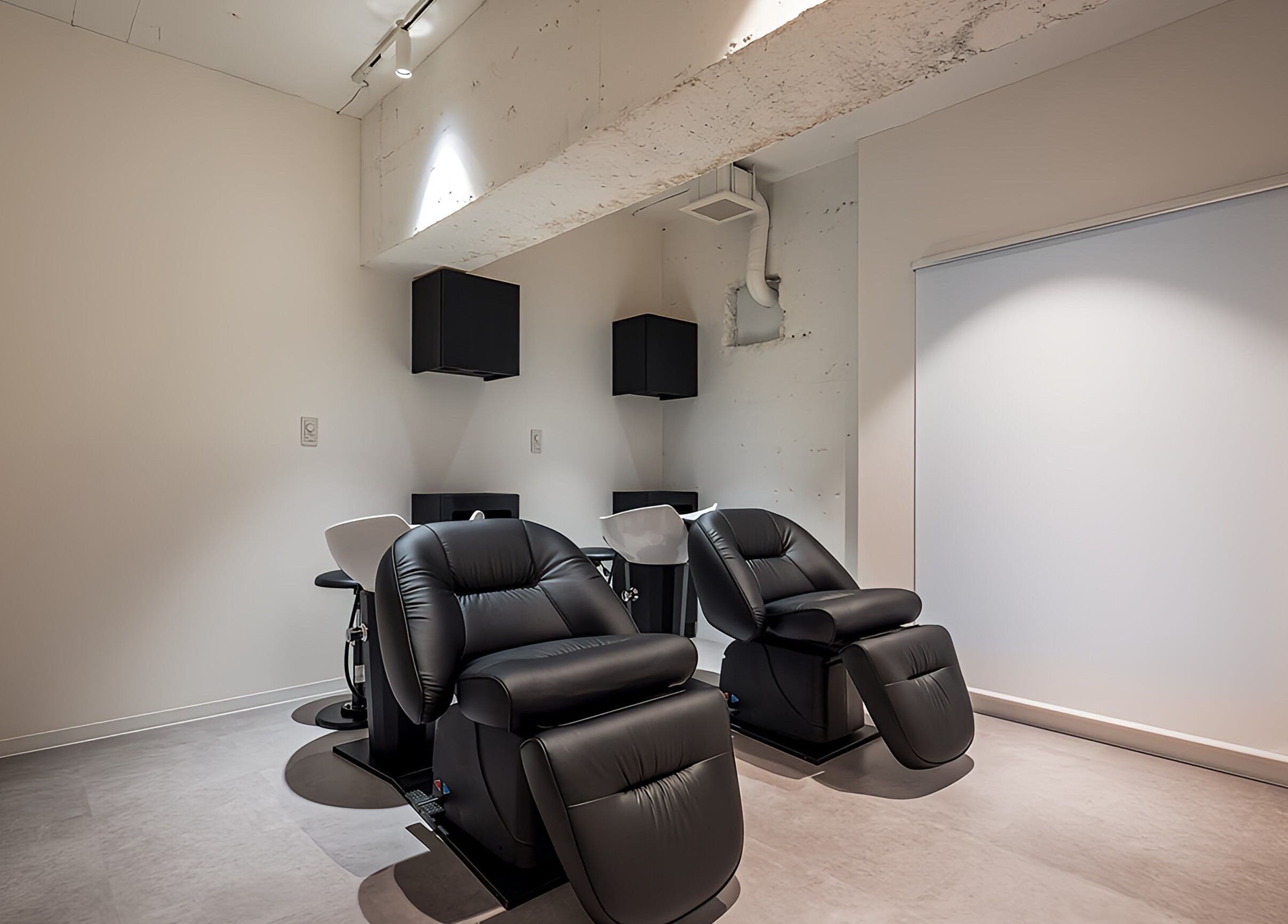 Relaxing black chairs in a modern studio at FÈATH, Minato City, Tokyo, JP.