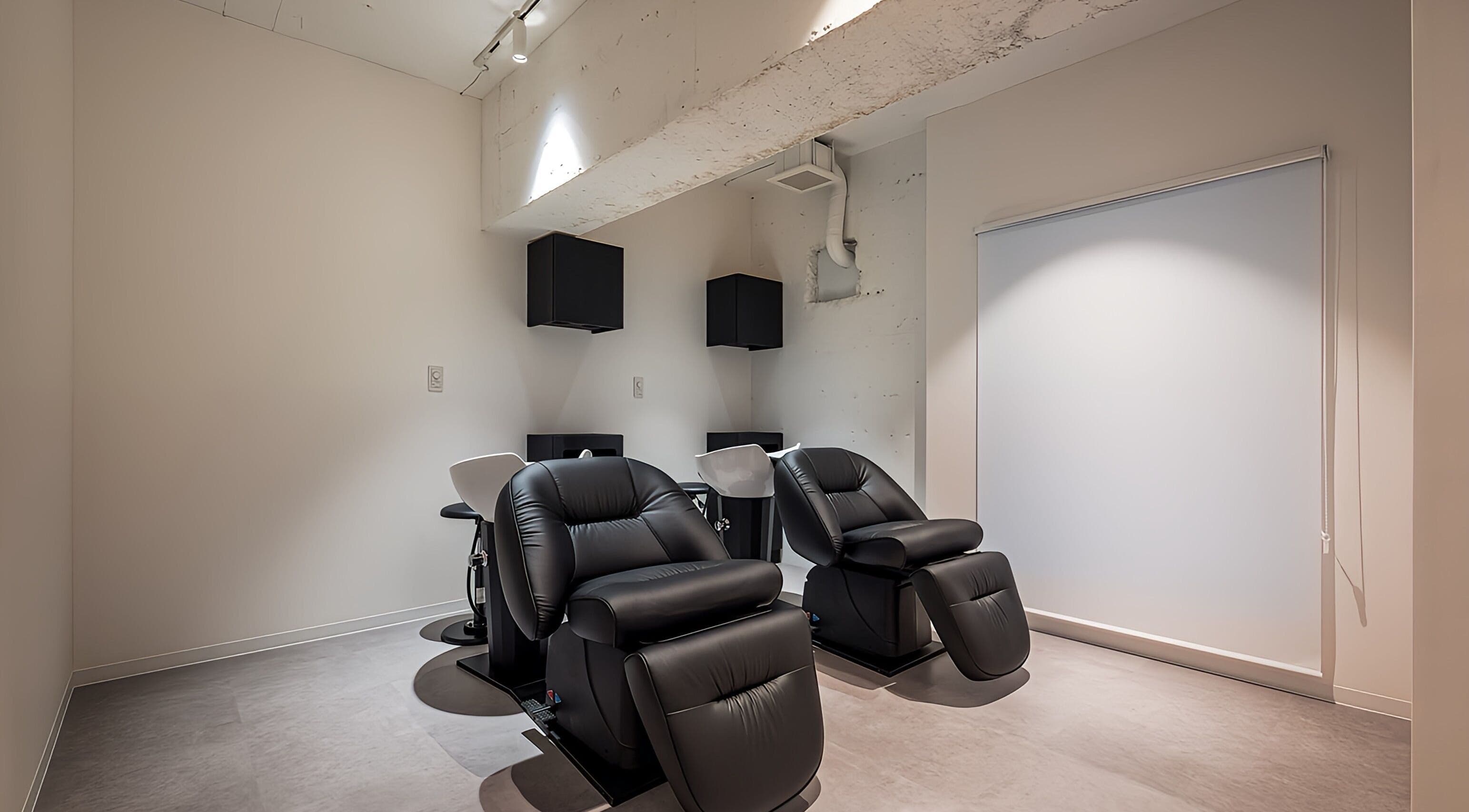 Relaxing black chairs in a modern studio at FÈATH, Minato City, Tokyo, JP.