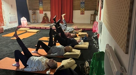 Group yoga session at Wired Counselling Service Wirral, cozy room, Wirral, England, GB.