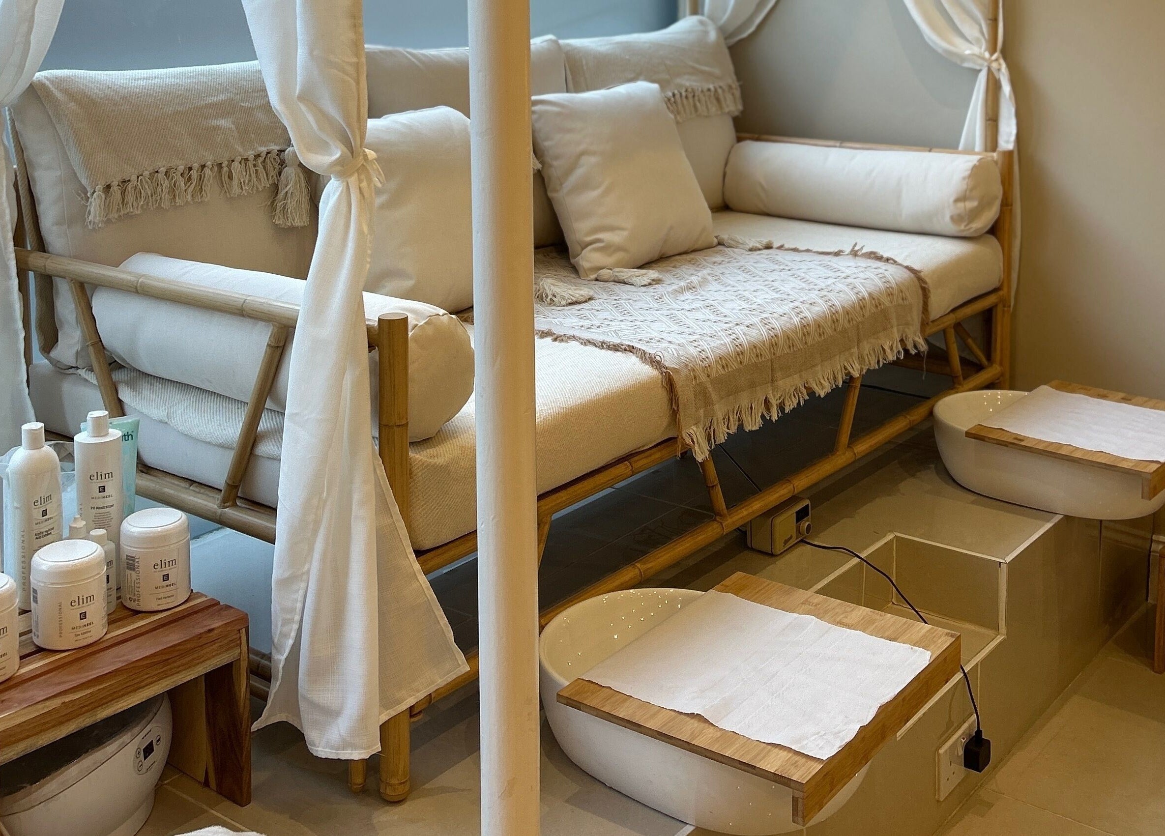 Elegant pedicure area at Ellie Glover Beauty, Lowestoft, England, GB with bamboo seating and skincare products.