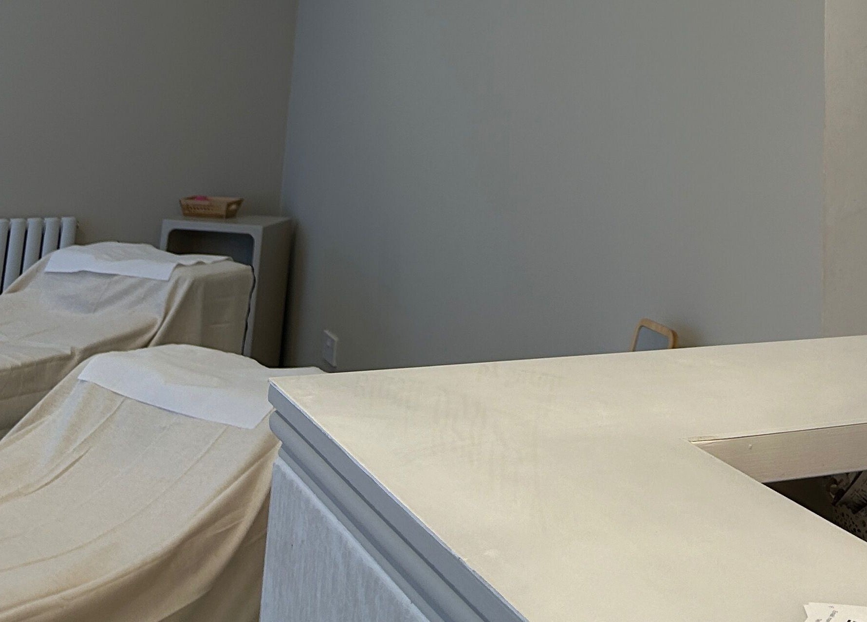 Serene treatment room at Ellie Glover Beauty, Lowestoft, England, GB, with two covered massage tables.