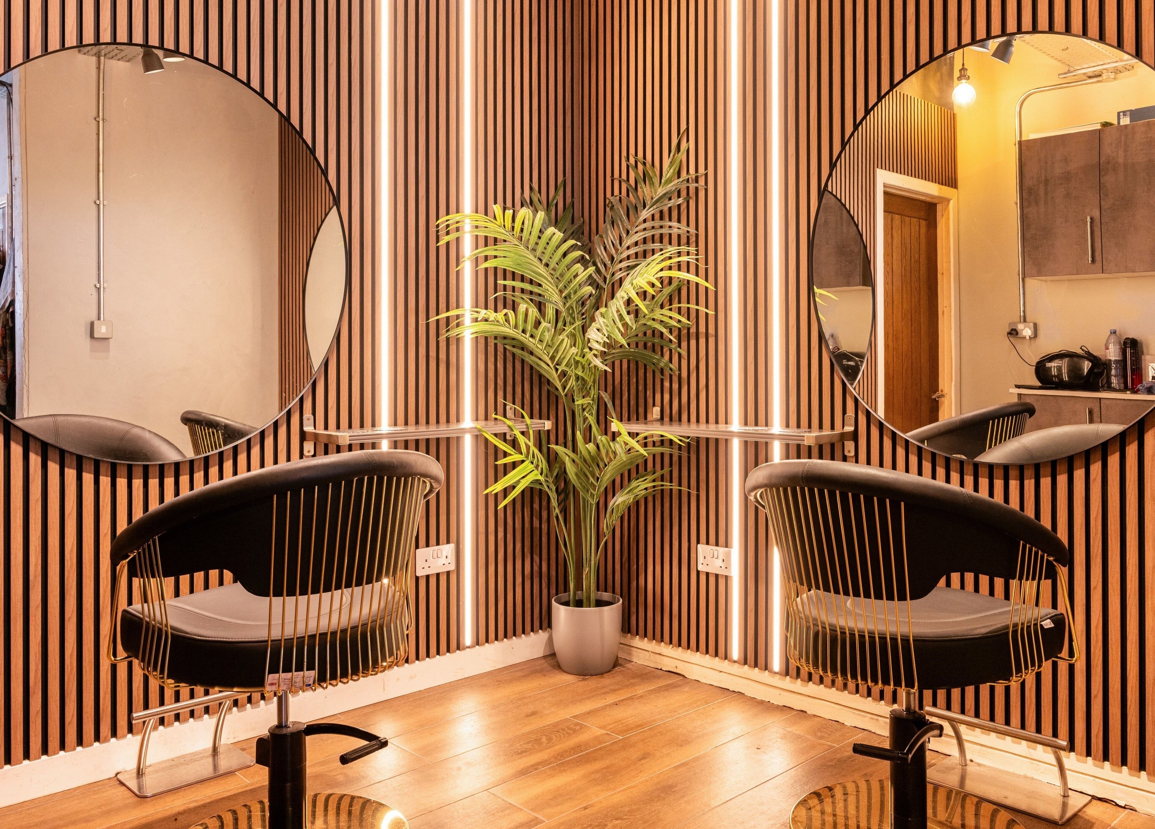 Stylish hair styling station at Glam Factory, Nuneaton, England, GB with circular mirrors and modern decor.