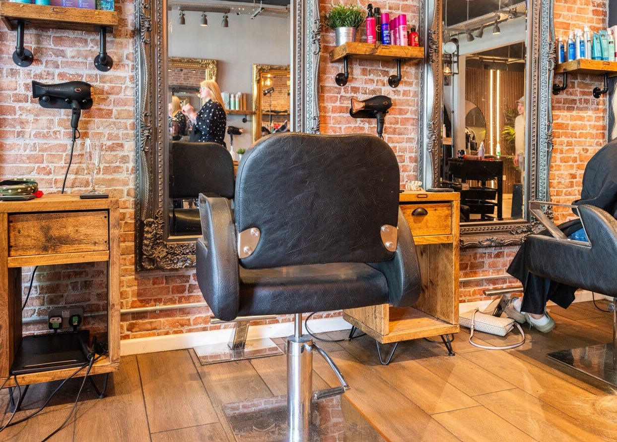 Chic salon interior at Glam Factory in Nuneaton, England, GB showcasing stylish chairs and elegant mirrors.