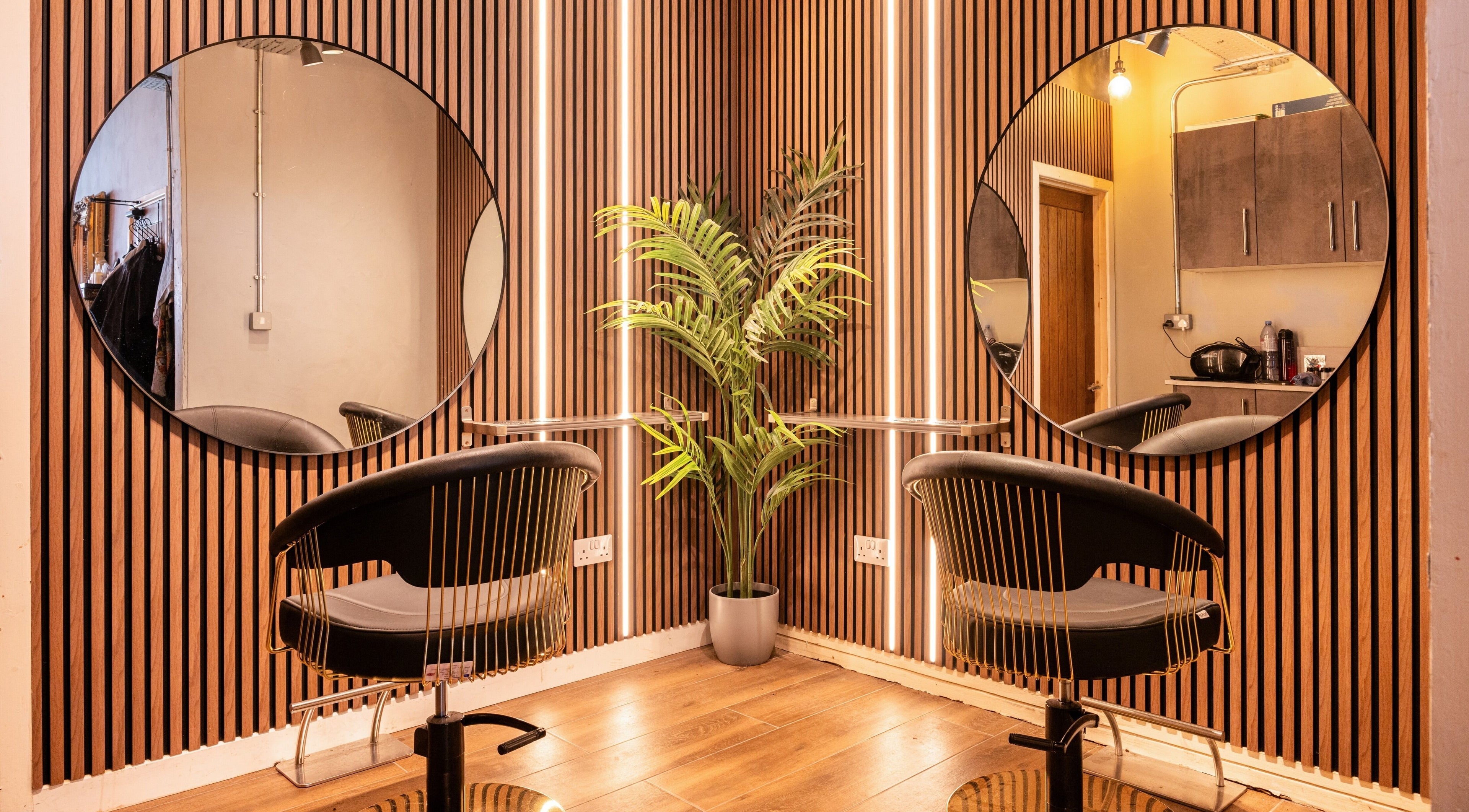 Chic salon station with mirrors at Glam Factory, Nuneaton, England, GB. Modern design with wood accents.