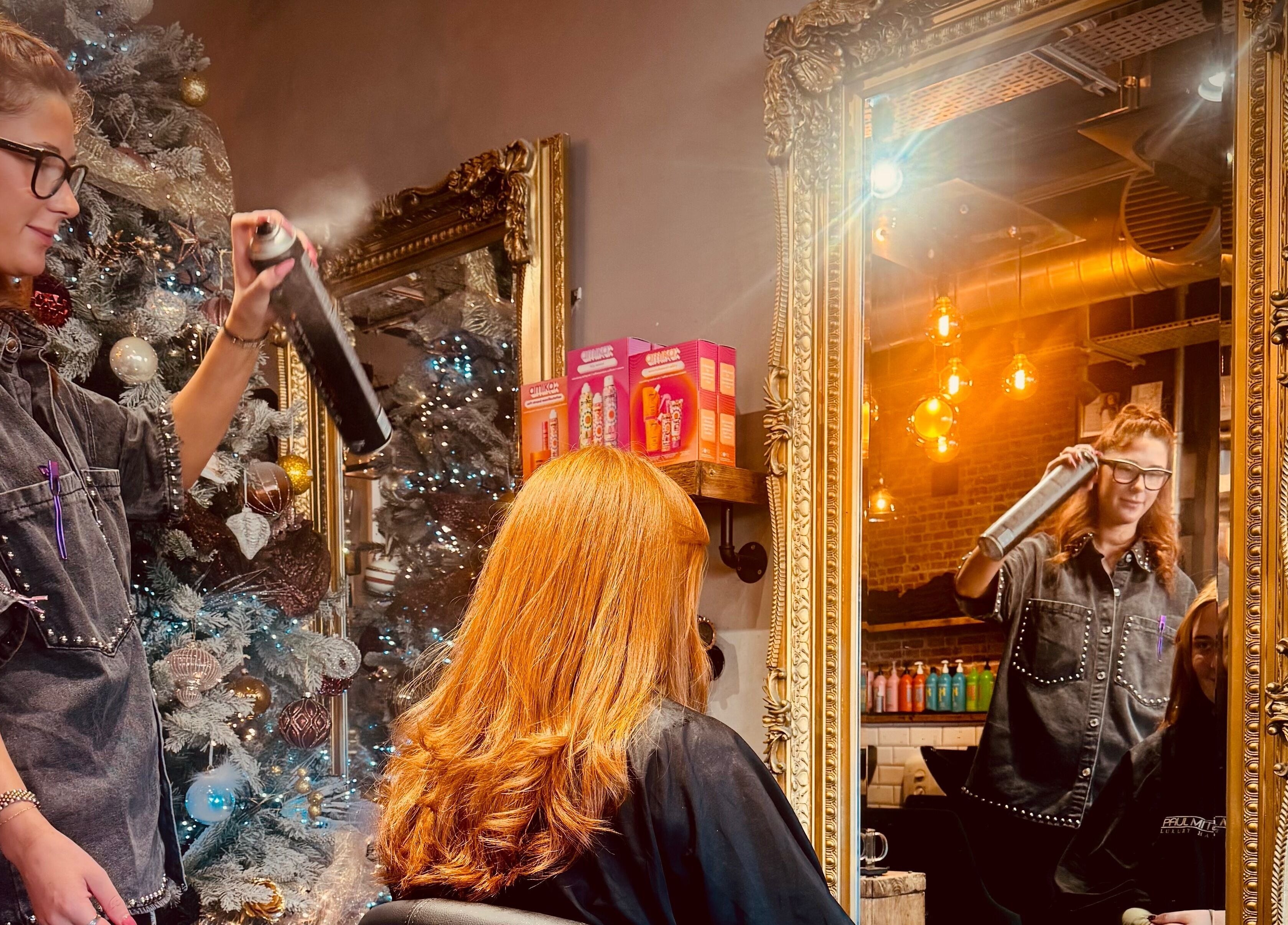 Stylist enhancing hair at Glam Factory in Nuneaton, England, GB amidst a chic salon interior.