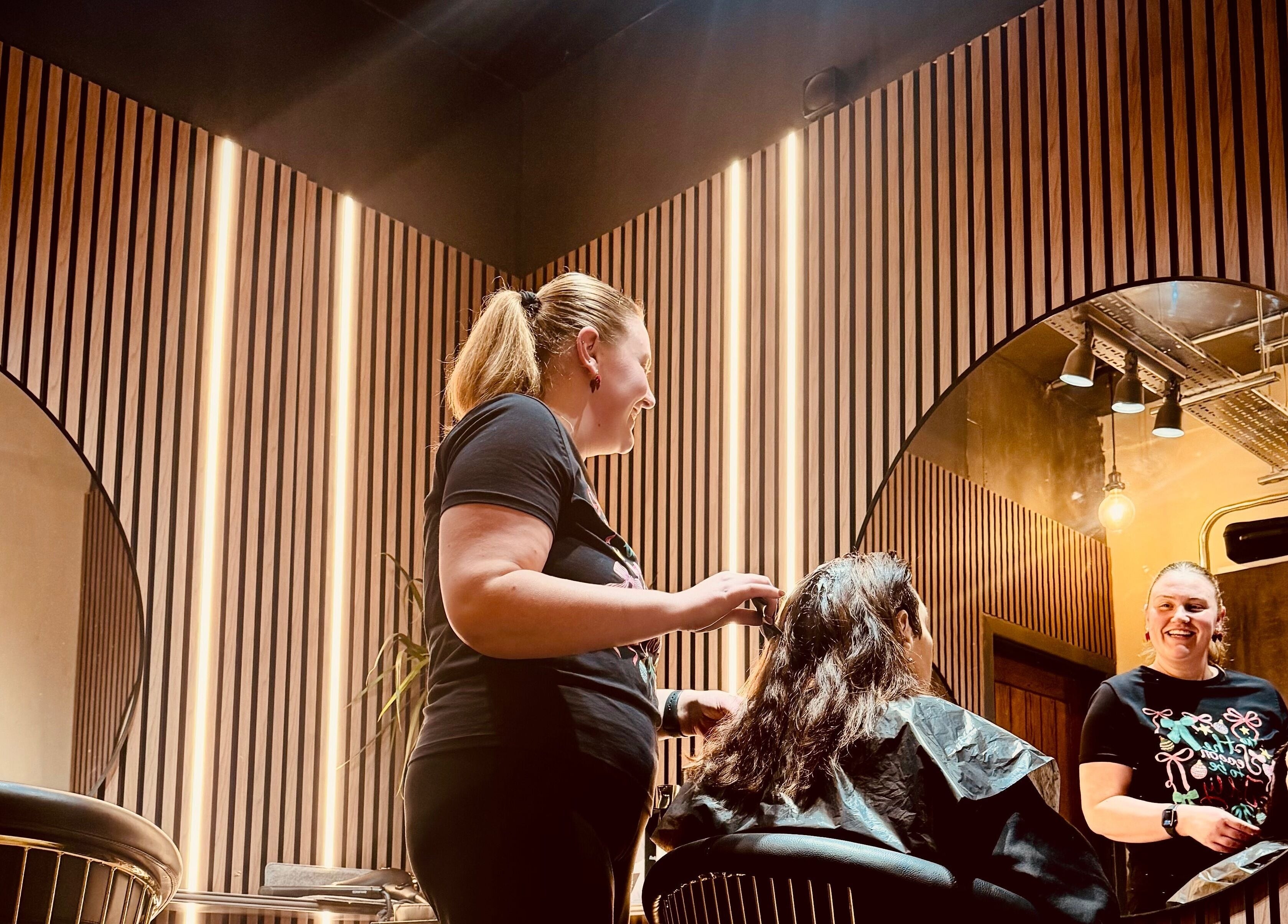 Professional hairdresser styling hair at Glam Factory salon, Nuneaton, England, GB.