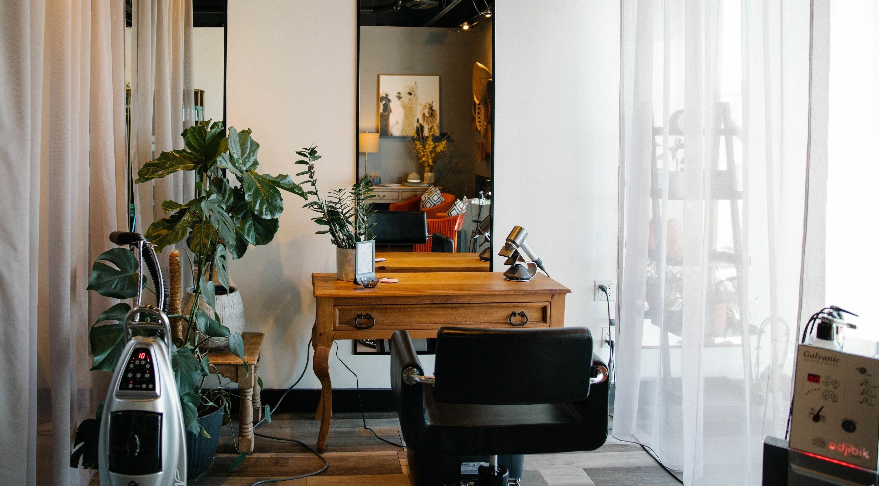 Cozy salon interior at Gyoker Hair Evolucio, Oakville, Ontario, CA with a stylish chair and wooden desk.