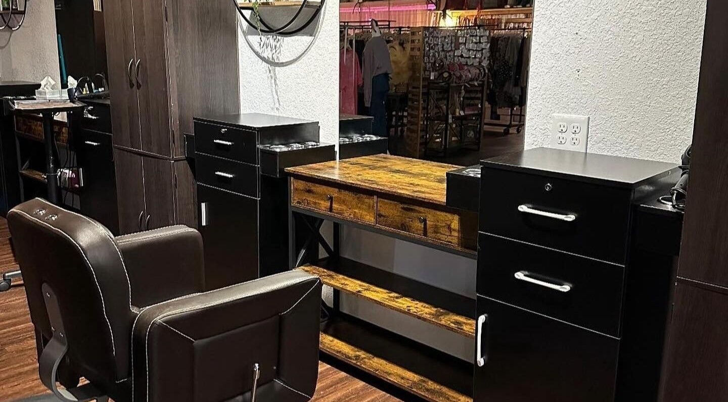 Modern salon workstation at Beauty Depot Salon, Blue Ridge, Georgia, US, with sleek chairs and wooden vanity.