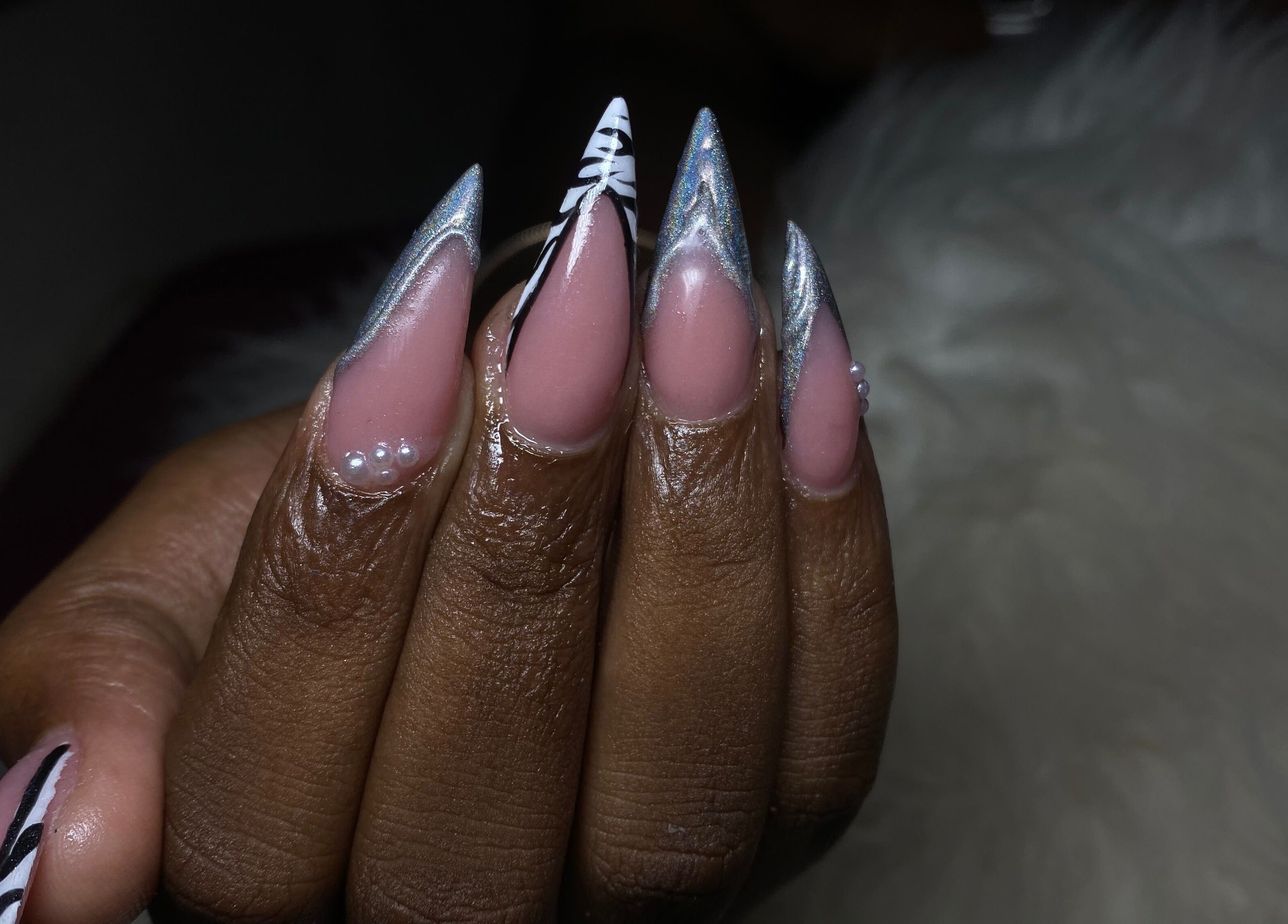 Intricate nail design at Belle luxe spa, Saint Michael, BB featuring pearl accents and silver details.