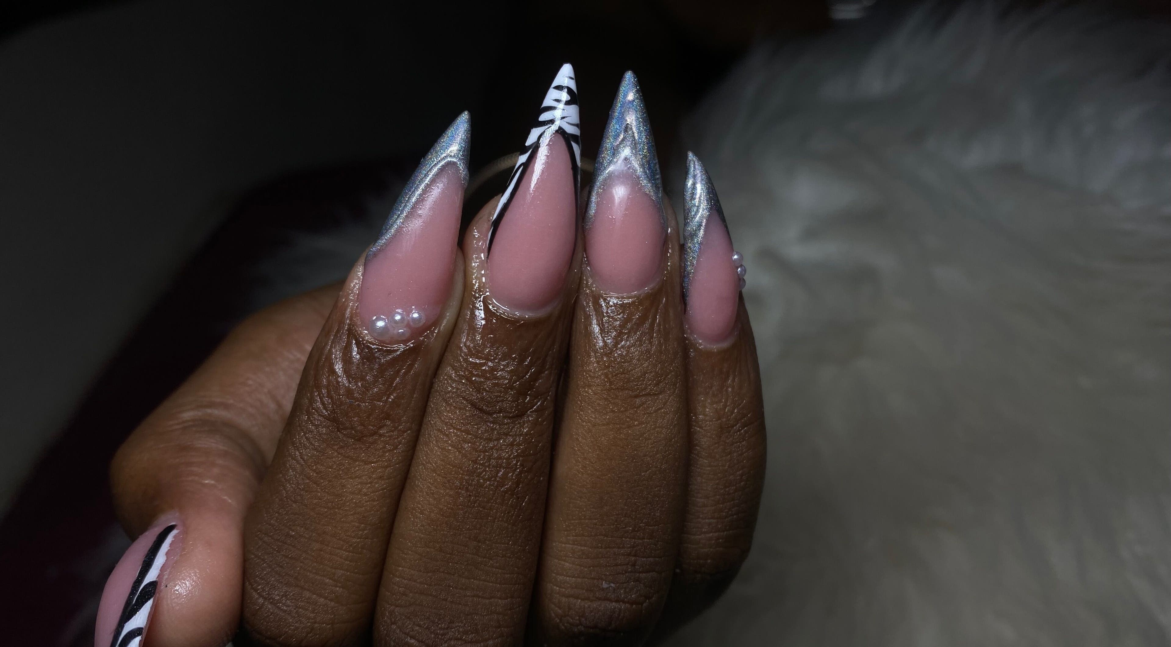 Intricate nail design at Belle luxe spa, Saint Michael, BB featuring pearl accents and silver details.